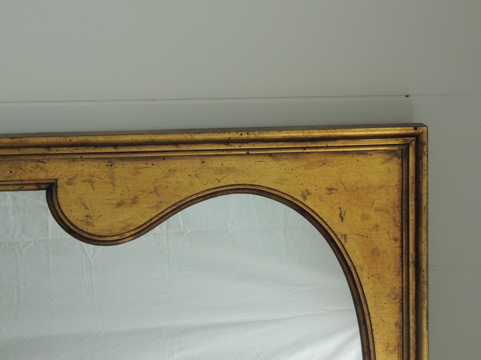 Tall vintage Arabesque style wood gold leaf wall mirror with original wood backing
and hanging hooks. (Very heavy)
Stamped South Carolina.
Size: 29 W x 49 1/4 L x 2 D.