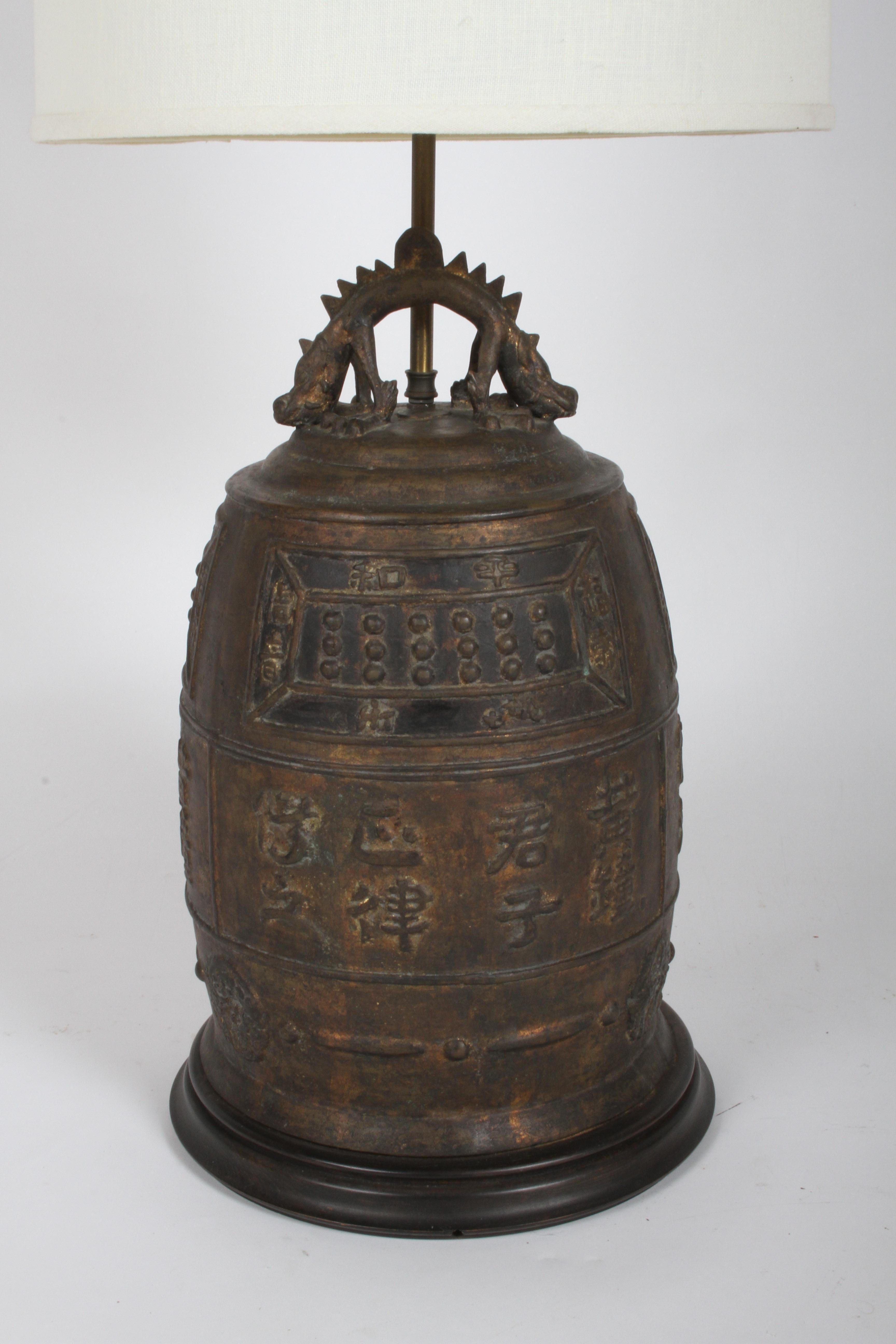 Large vintage Asian / Oriental table lamp of a bronze drum with symbols, signs of gilt , with two headed dragon at top. Came out of an interior of a mid-century modern home, possibly from the 50's or earlier. Working condition, will get new cord,