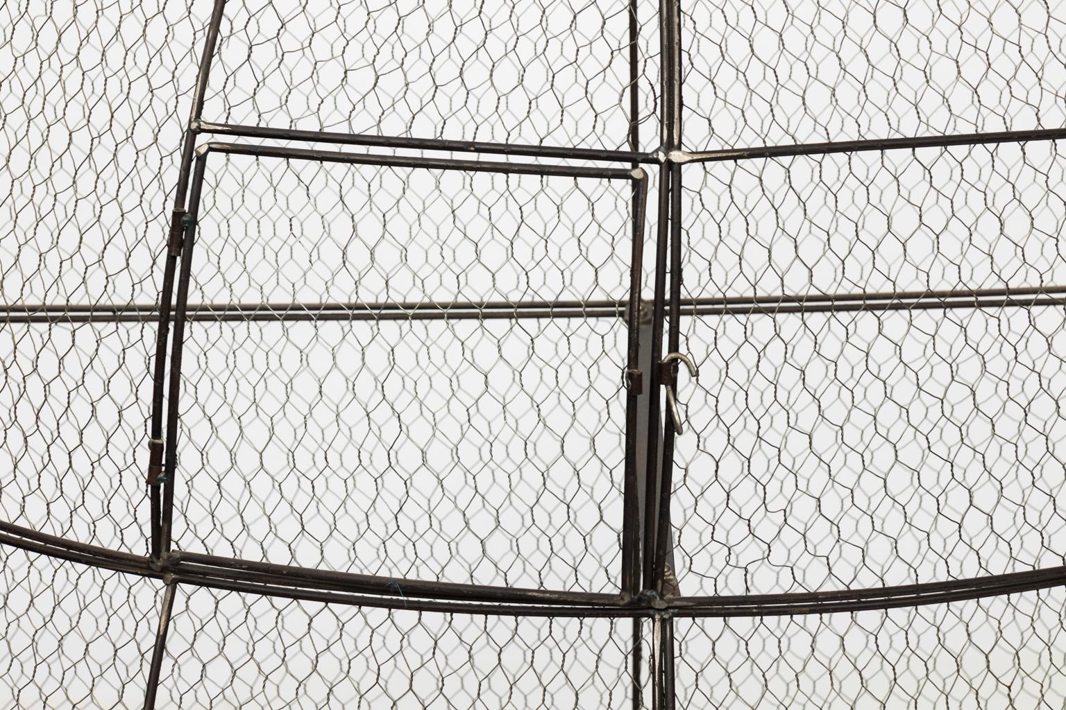 Large vintage birdcage with two removable tray at bottom. Wood bird included, (which is removable). Can also be used as a decorative item or planter. There are three doors that open for access.
 