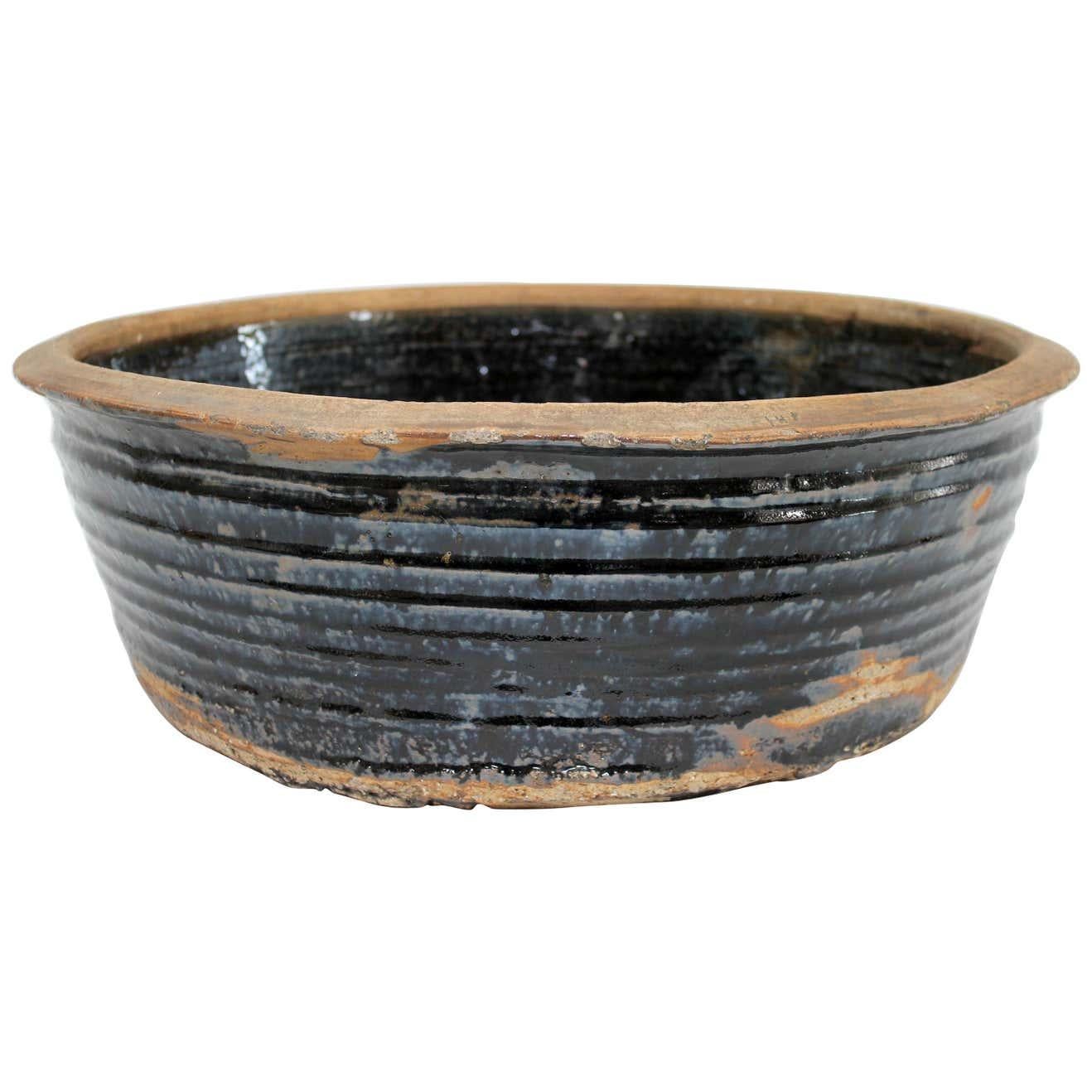 Large vintage black glazed terracotta bowl
Size: 20
