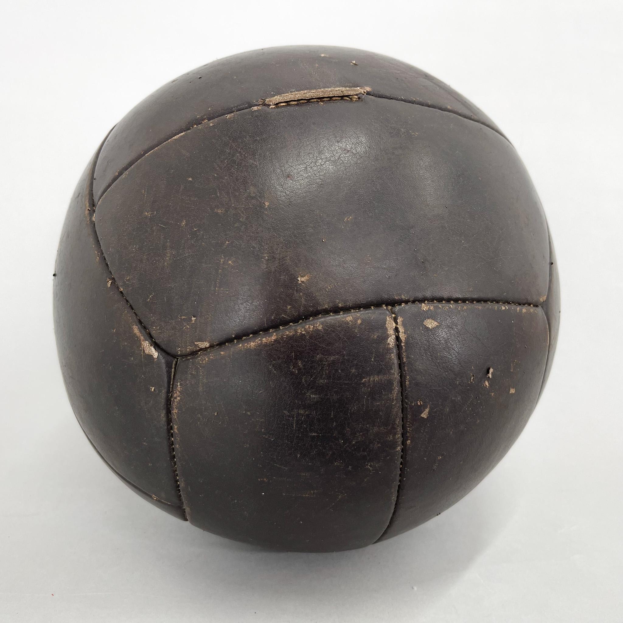 Original vintage heavy leather training ball with beautiful patina. The ball is made of handstitched genuine leather in former Czechoslovakia in the 1930s. It can be used as an original interior accessory or as a stylish training aid. The leather