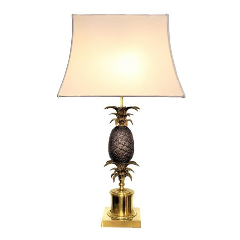 This large pineapple lamp is made of a brass base with a mounted detailed bronze pineapple. It is very similar to the lamps designed by Maison Charles and dates to the 1970s. 

The shades are show models and not part of the sale.

Measurements (with