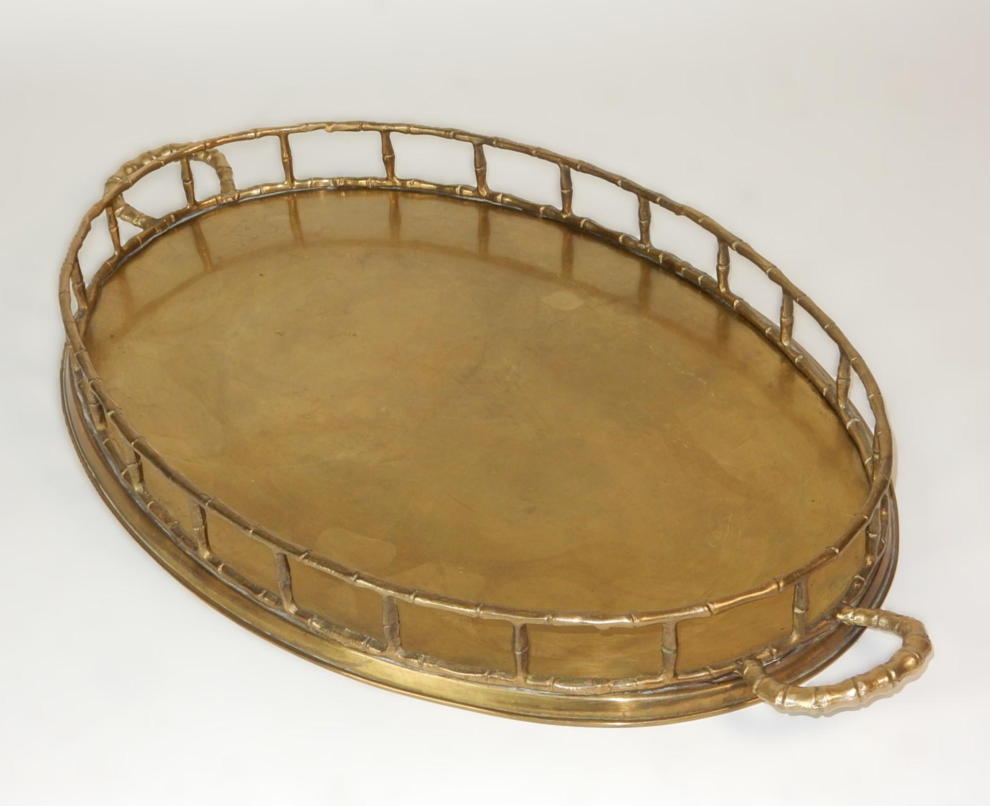 Large brass service tray with faux bamboo trim and handles.
Circa 1970's, Tiawan origin. Over 2 feet across(25