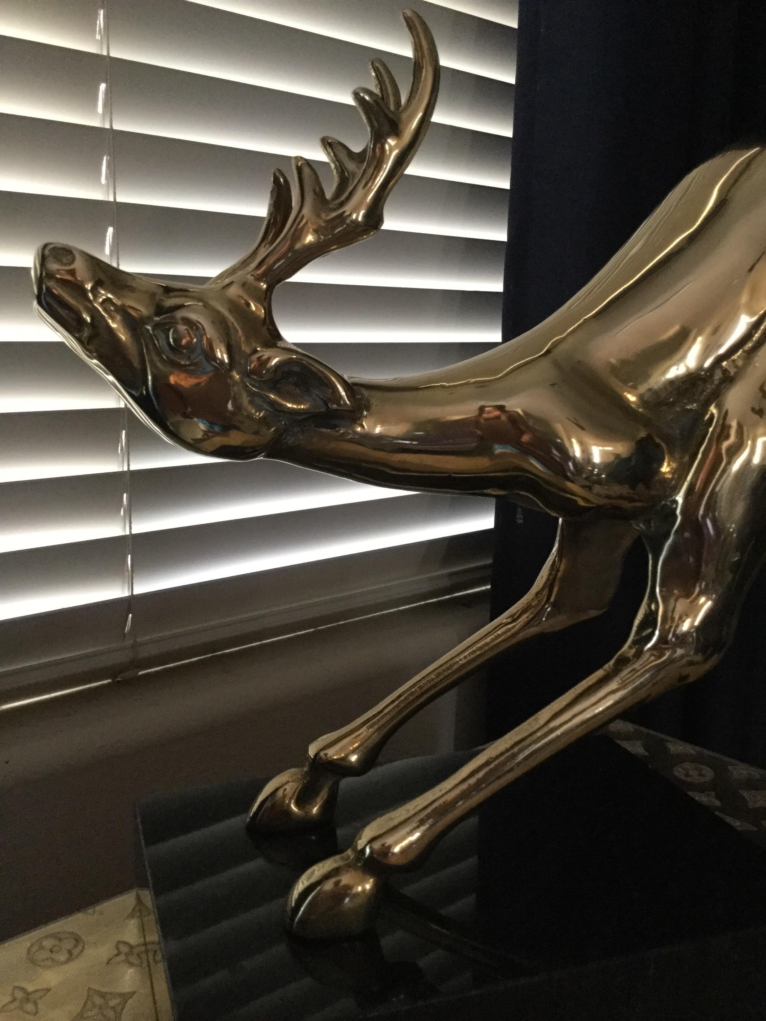 A rare vintage brass animal statue from 1980s. Newly polished. Jumping reindeer appears to be in flight attached to the marble base.