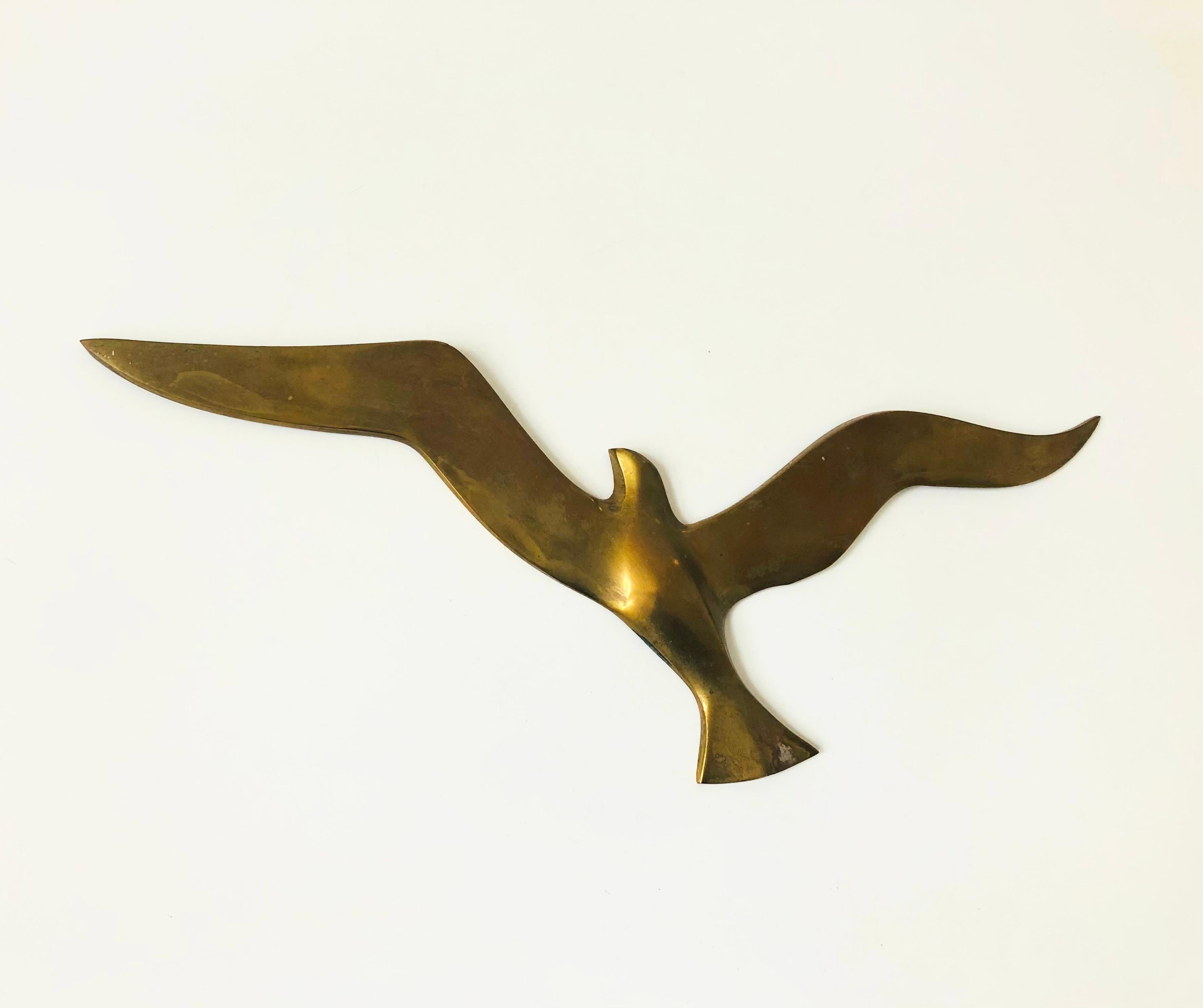 A large vintage brass wall hanging of a seagull in flight. Ready to hang by 2 hoops on the back.
 