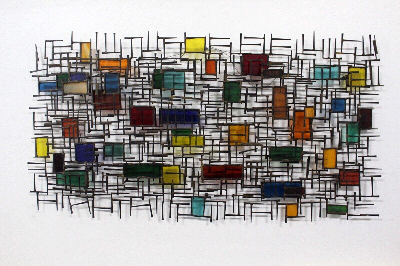 For your consideration is this showstopping vintage brutalist nail and multicolored stained glass wall sculpture. Dimensions: 48.5W x 2.75D x 25H.
 