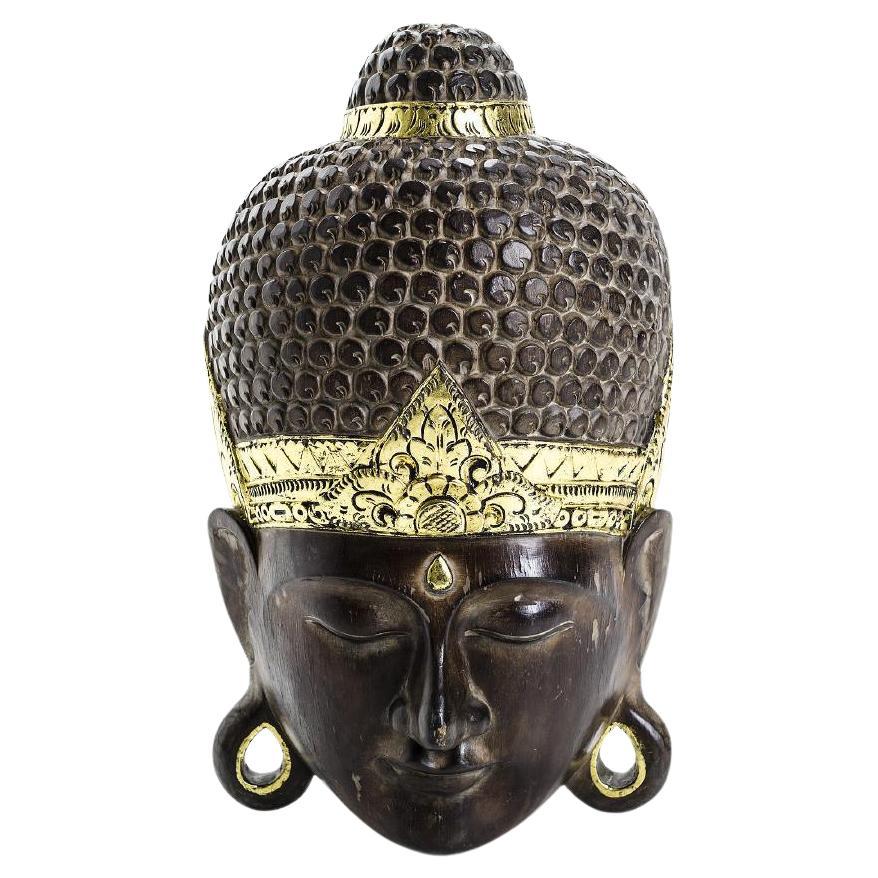 Large vintage hand-carved from one piece of solid wood Buddha mask with gold leaf embellished lotus headdress. 
Beautifully hand carved & painted, it has a hook, ready to hang. Carved signature to the top backside. Artisan crafted in Bali. 
Circa 70