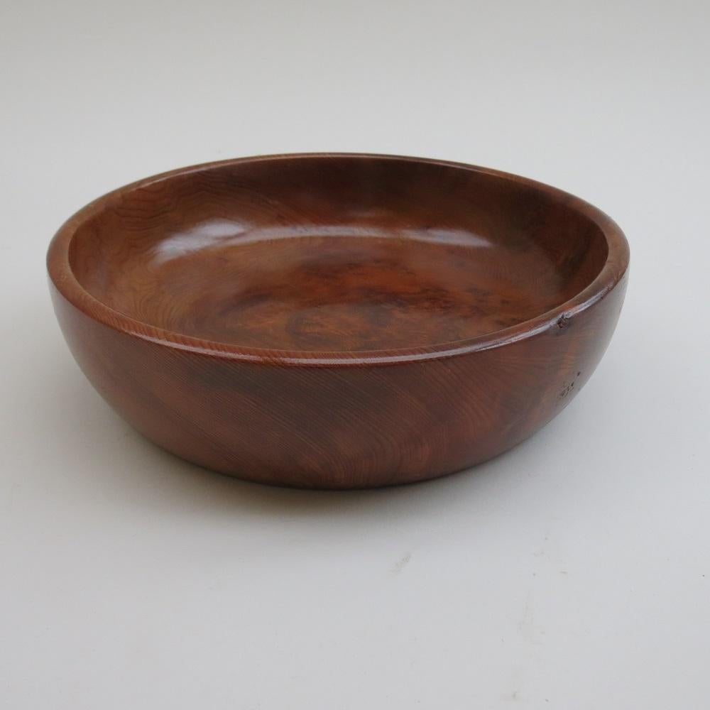 A large wooden bowl, dates from the 1970s, hand turned from solid Californian Redwood. In good condition, has been refinished. 
Label to the underside reads Californian Redwood.