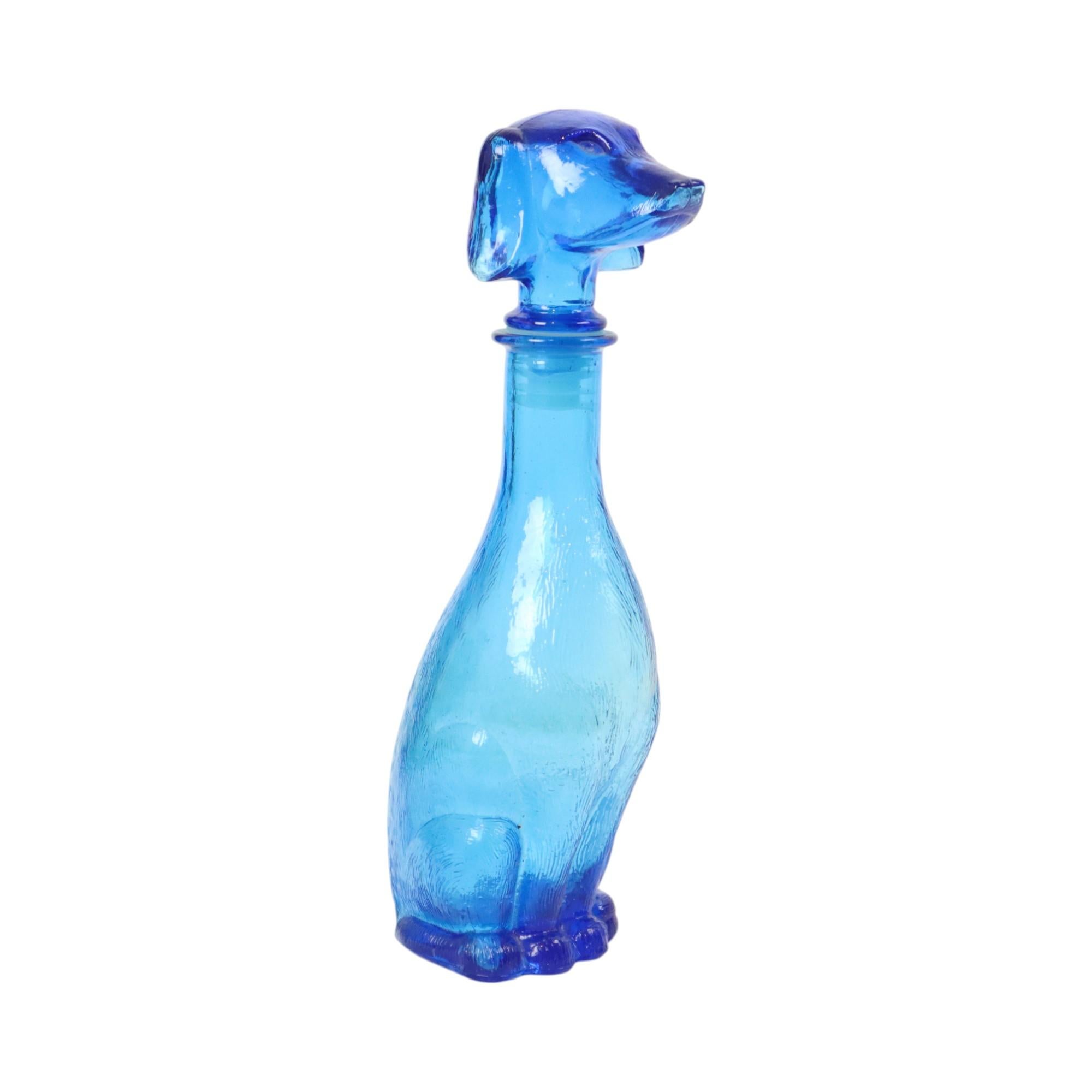 Italian decorative decanter of clear blue glass in the shape of a sitting dachshund, dachshund. Made in the glass factory in Empoli in the 1960s.

In this type of bottles Italian red wine was sold, these bottles now have a decorative value and are