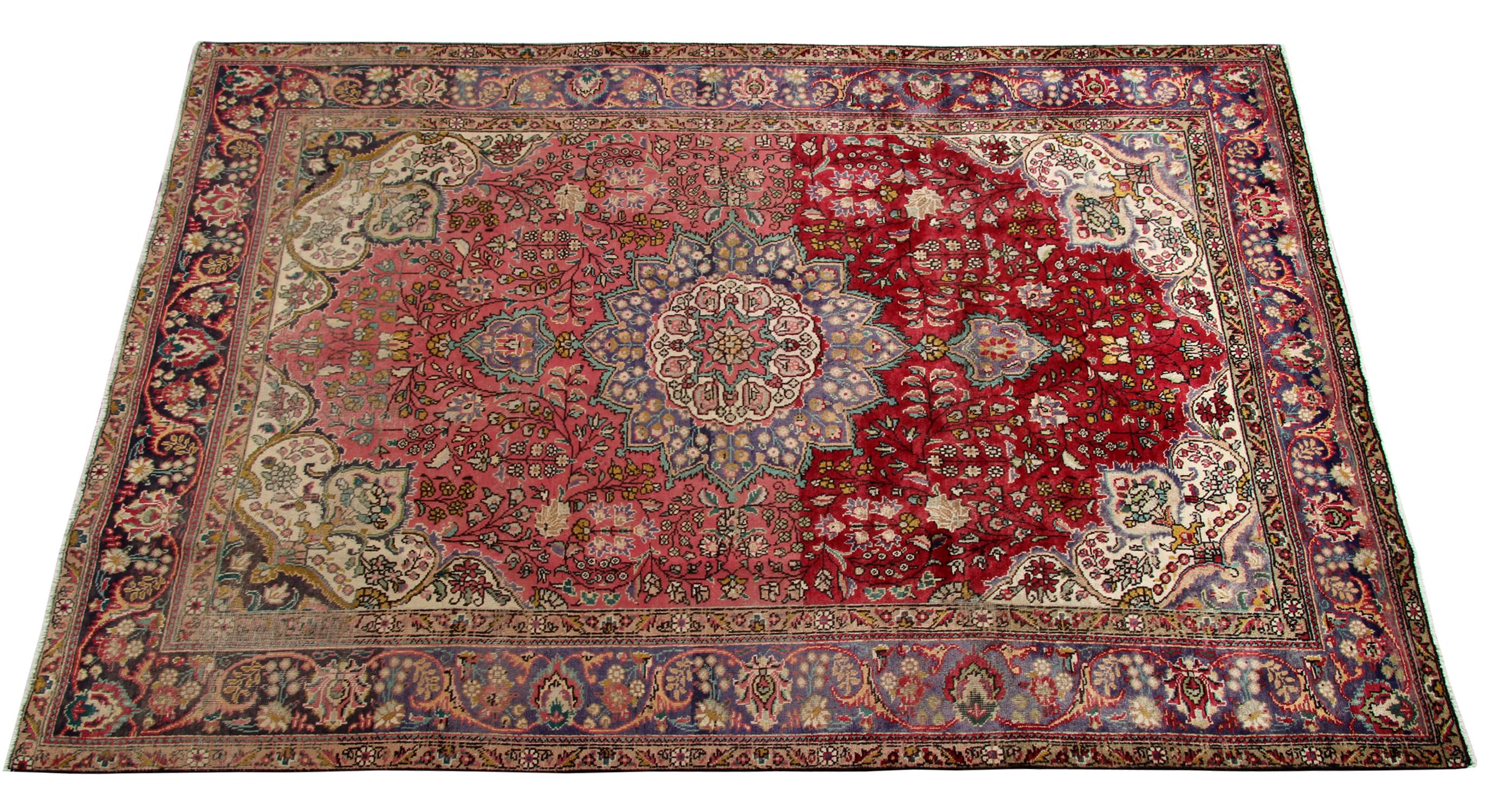 This beautiful wool rug is a fantastic example of rugs woven in the 1970s. It features a traditional elegant central medallion design. It is enclosed by a highly detailed surrounding design and border and woven in a fantastic array of accent