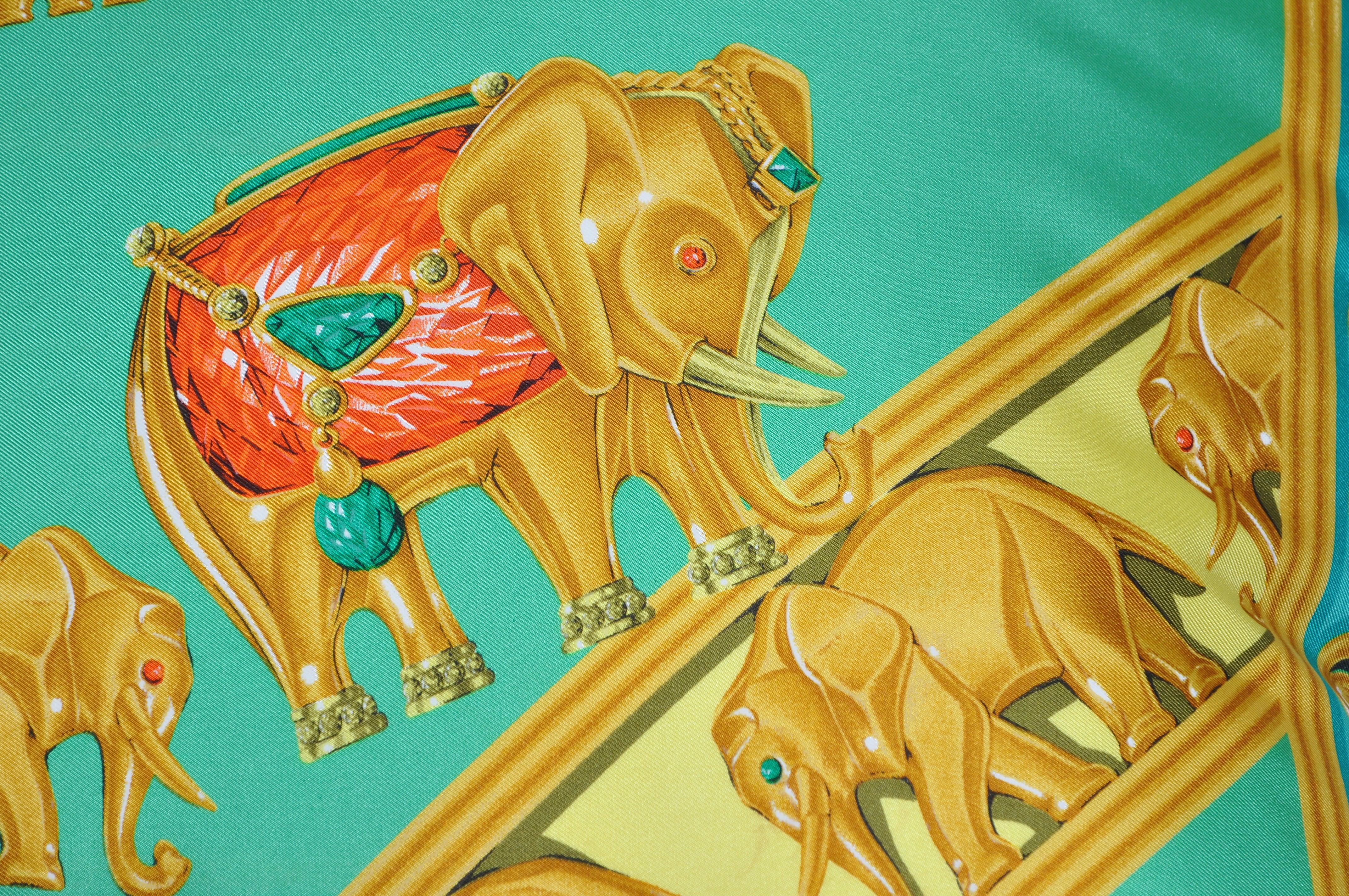 Large custom made one-of-a-kind luxury cushion (pillow) created from an exquisite rare vintage pure silk Cartier fashion scarf in a striking print. It illustrates exotic elephants in procession adorned with fabulous jewels. They spiral around the