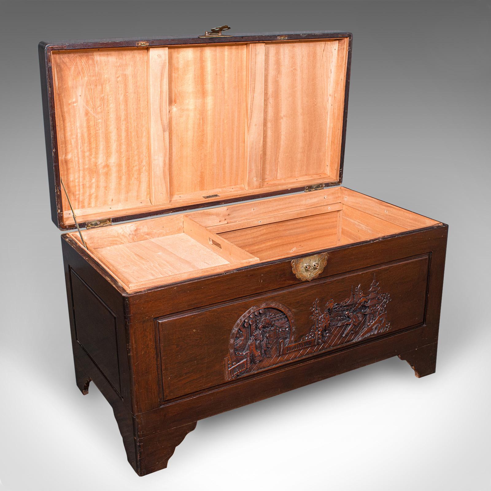 This is a large vintage carved chest. A Hongkongese, camphorwood storage trunk, dating to the mid 20th century, circa 1950. A fine example of Oriental craftsmanship, with rich colour and ornate carved detail.

Of delightful proportion, ideal as a