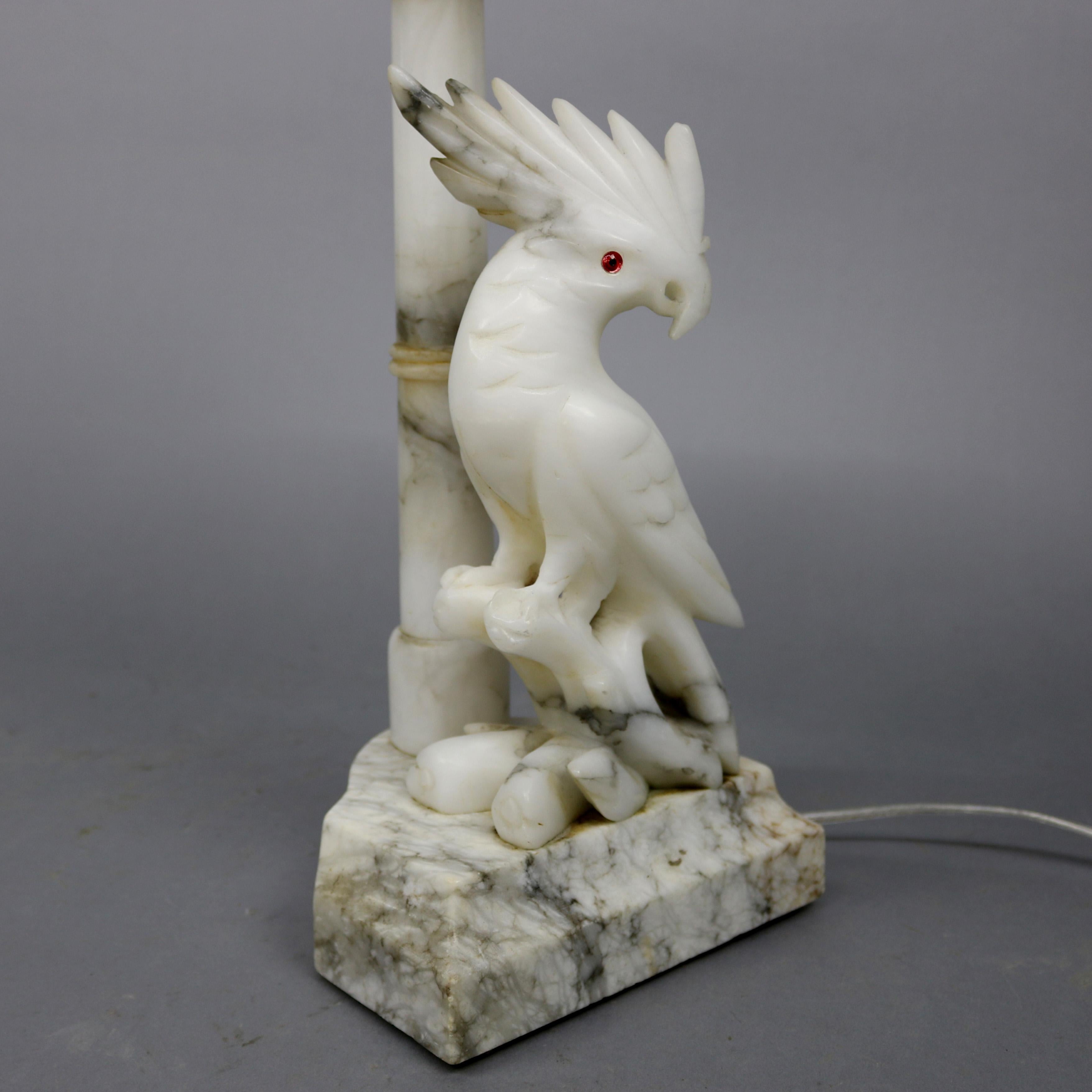 A vintage large figural table lamp offers finely carved Italian marble and alabaster construction with umbrella cockatoo sculpture seated on branch, circa 1930,

Measures: 21.75
