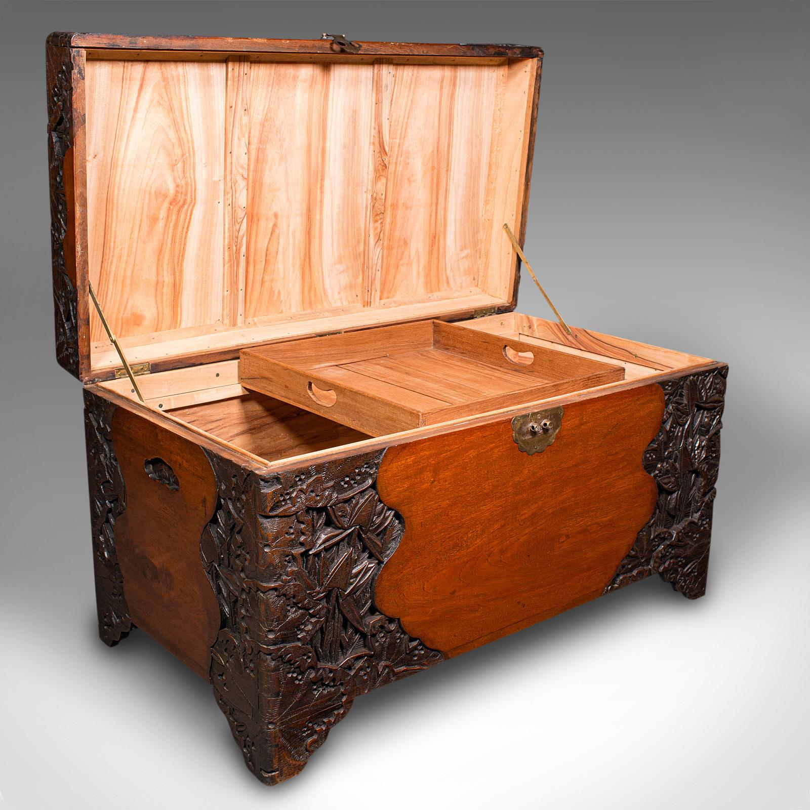 This is a large vintage carved linen chest. An Oriental, teak and camphorwood trunk with Art Deco taste, dating to the early 20th century, circa 1930. 

Exquisite craftsmanship, profusely carved and of substantial proportion
Displaying a desirable