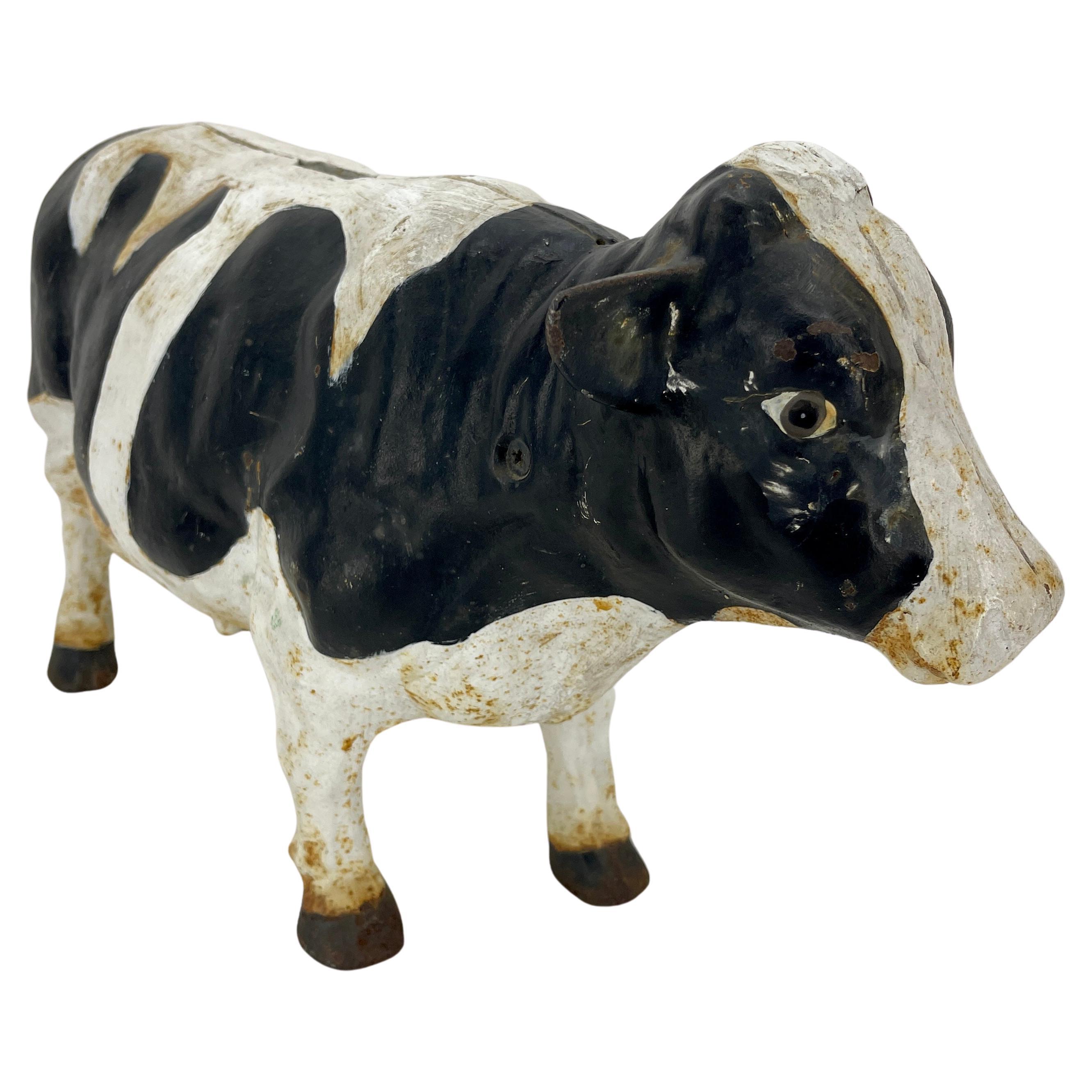 Large Vintage cast iron black and white piggy money bank cow.