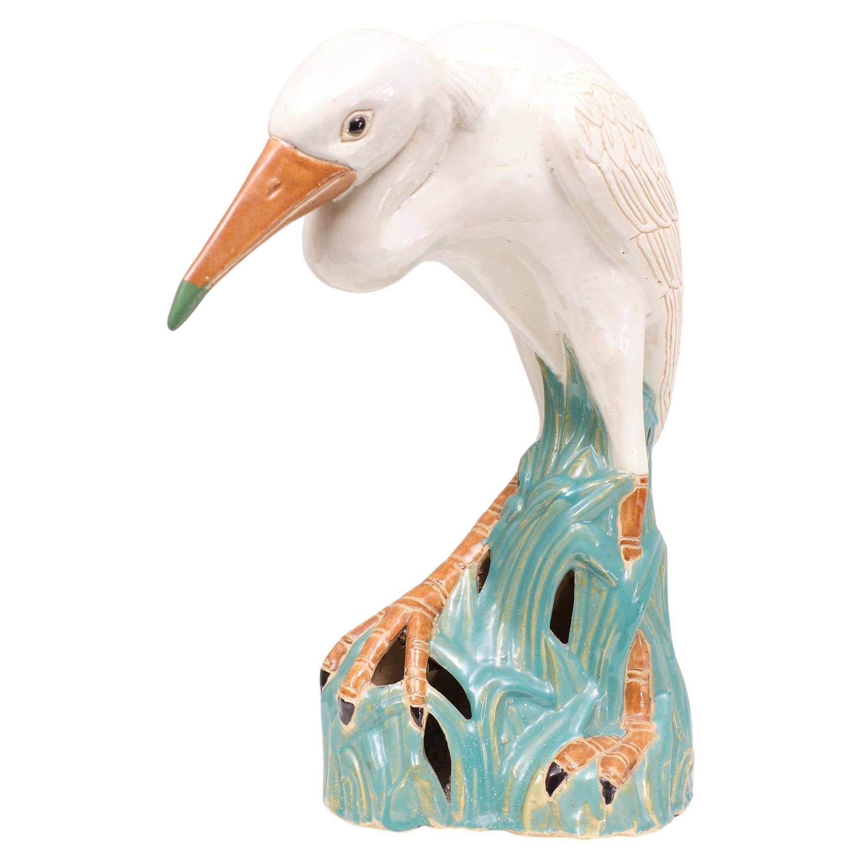 Very nice life size glazed Ceramic  figurine of a Heron .Standing with its feet in the high grass Beautiful Sea Green color . Very good condition . 
.