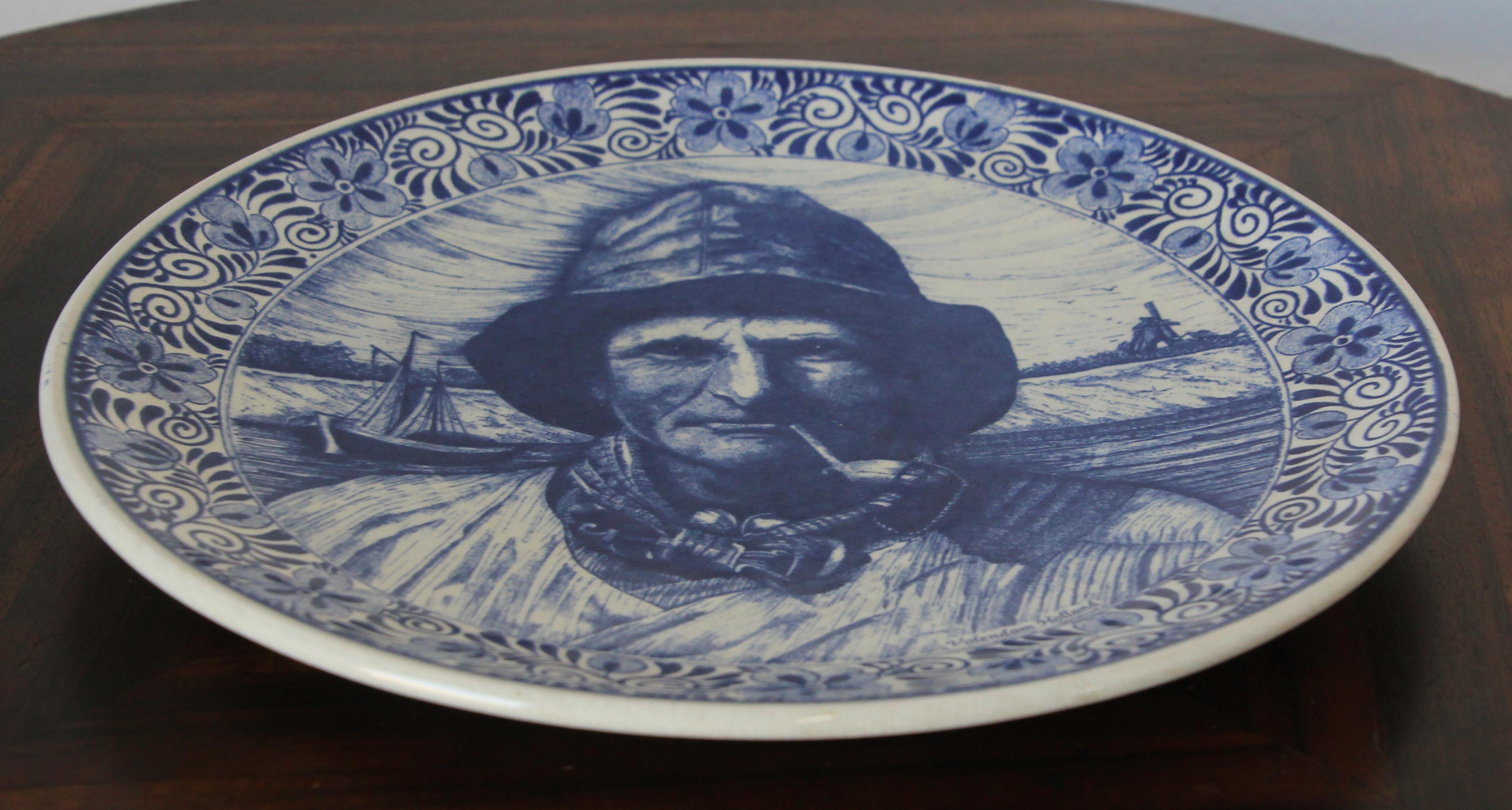 Stunning large vintage Dutch Holland Delfts blue and white decorative plate.
Beautiful charger, the painting depicts a fisherman smoking a pipe.
 It is signed by the artist, 