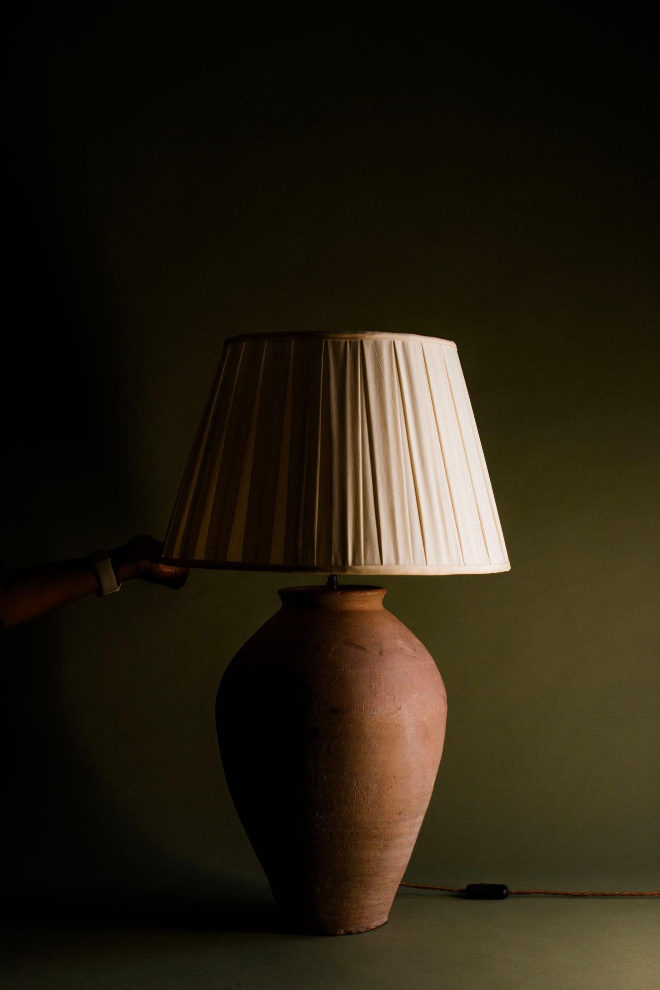 A large vintage Turkish terracotta table lamp with a classic rounded shape and warm natural clay finish. Handmade using traditional Anatolian techniques, this piece showcases the distinctive surface patina and texture typical of vintage Turkish