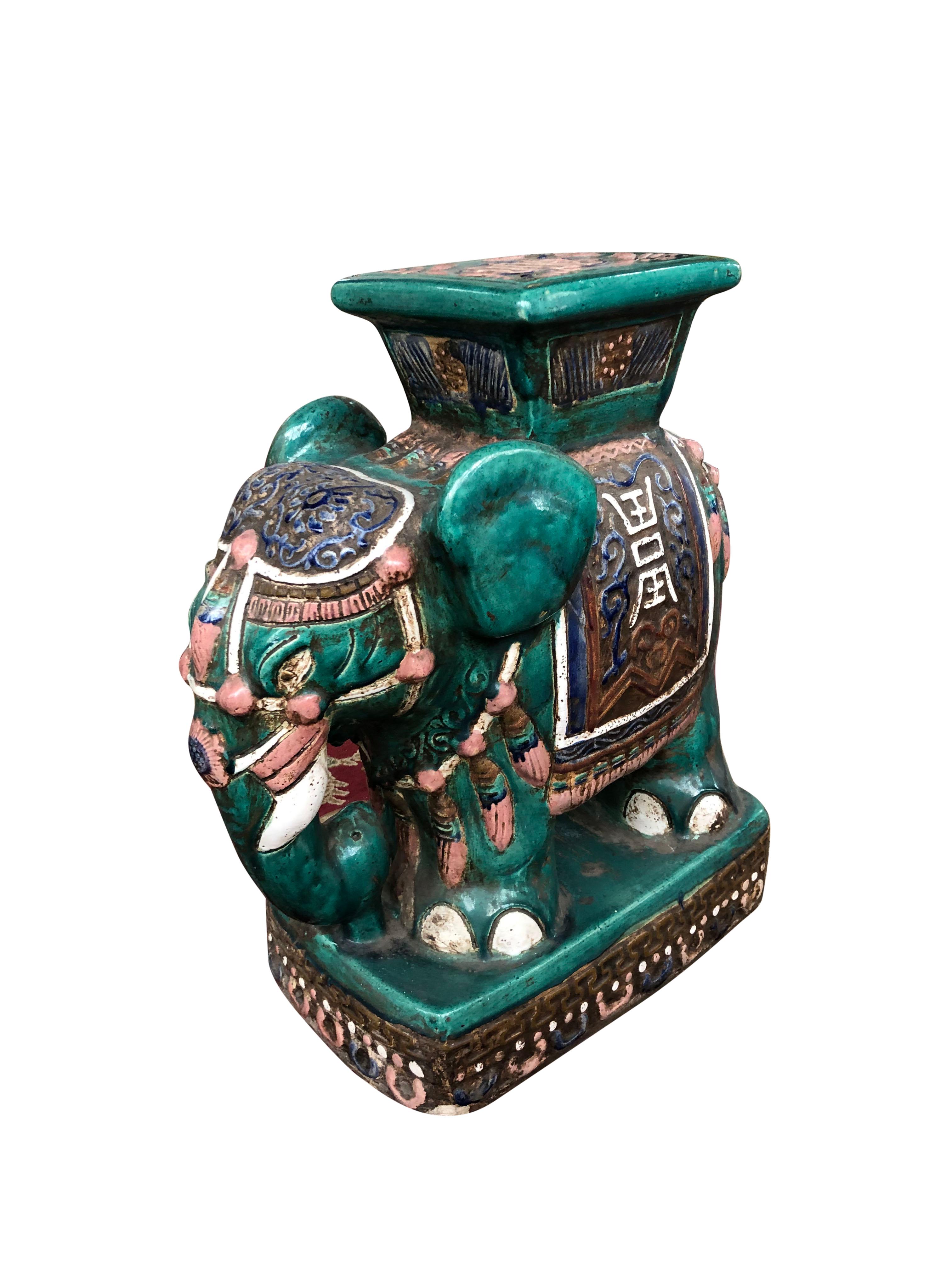 A superb and unusual large vintage Chinese ceramic elephant pedestal, 20th century. Standing at over 2 feet tall and designed with beautiful colours and patterns. Offered in good condition and ready for use.