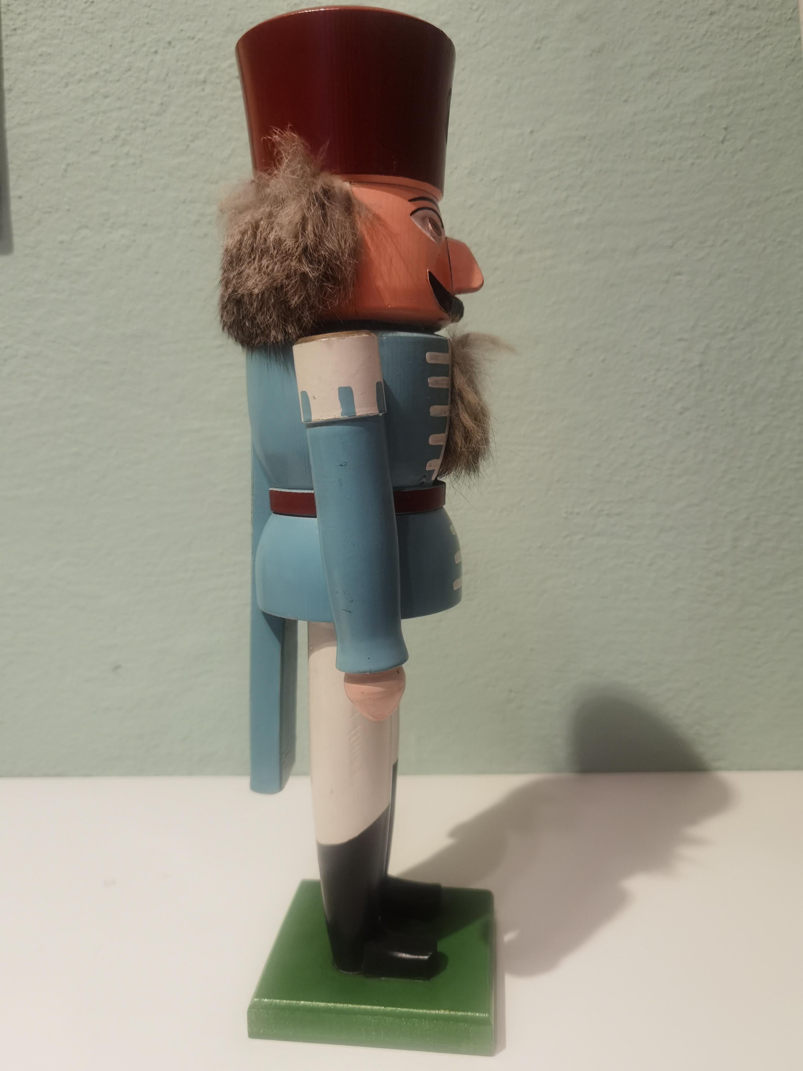 Large vintage wooden nutcracker figure from the Erzgebirge. The region Erzgebirge formerly Eastern Germany is famous for this special kind of nutcrackers, where intricate carving has been their home. Completely hand-painted in light blue and white