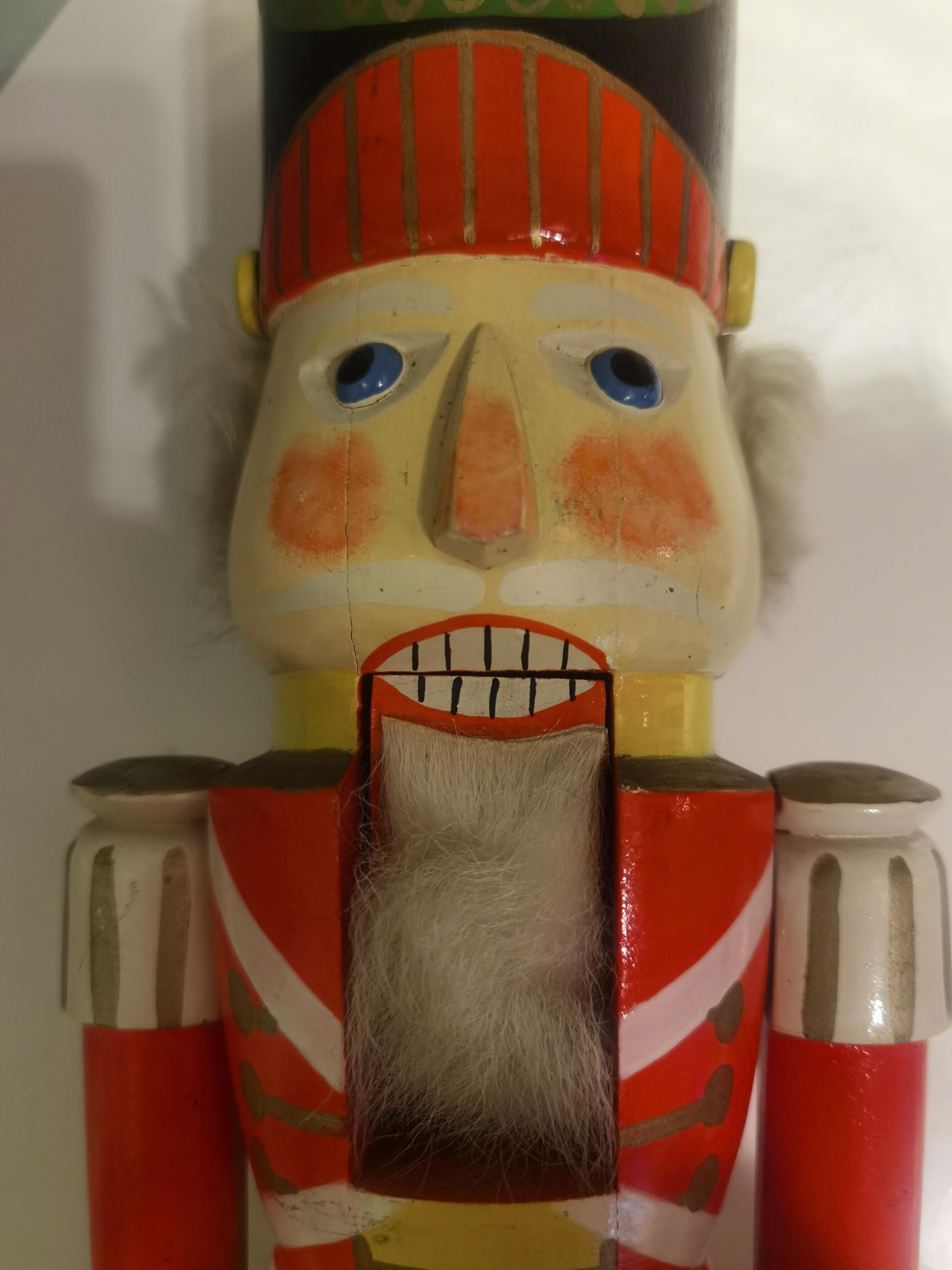 Large vintage wooden nutcracker figure from the Erzgebirge. The region Erzgebirge formerly Eastern Germany is famous for this special kind of nutcrackers, where intricate carving has been their home. Completely hand-painted in blue and red colors