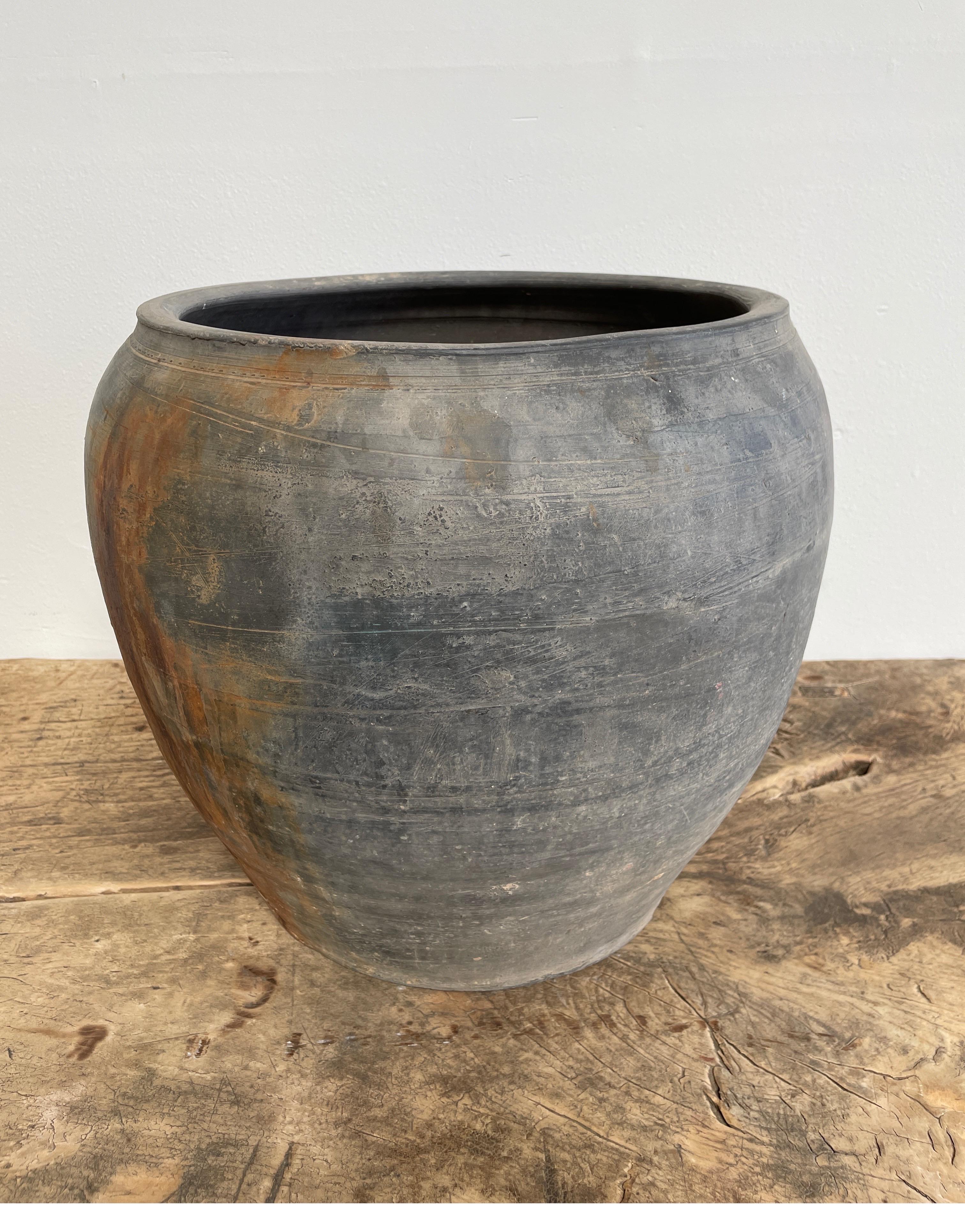 Vintage Pottery

Beautiful and rich in character, this vintage oil pot adds just the right amount of texture + warmth where you need it. Stunning faded black/ brown unglazed finish with warm terra-cotta accents.
Some have a more faded appearance