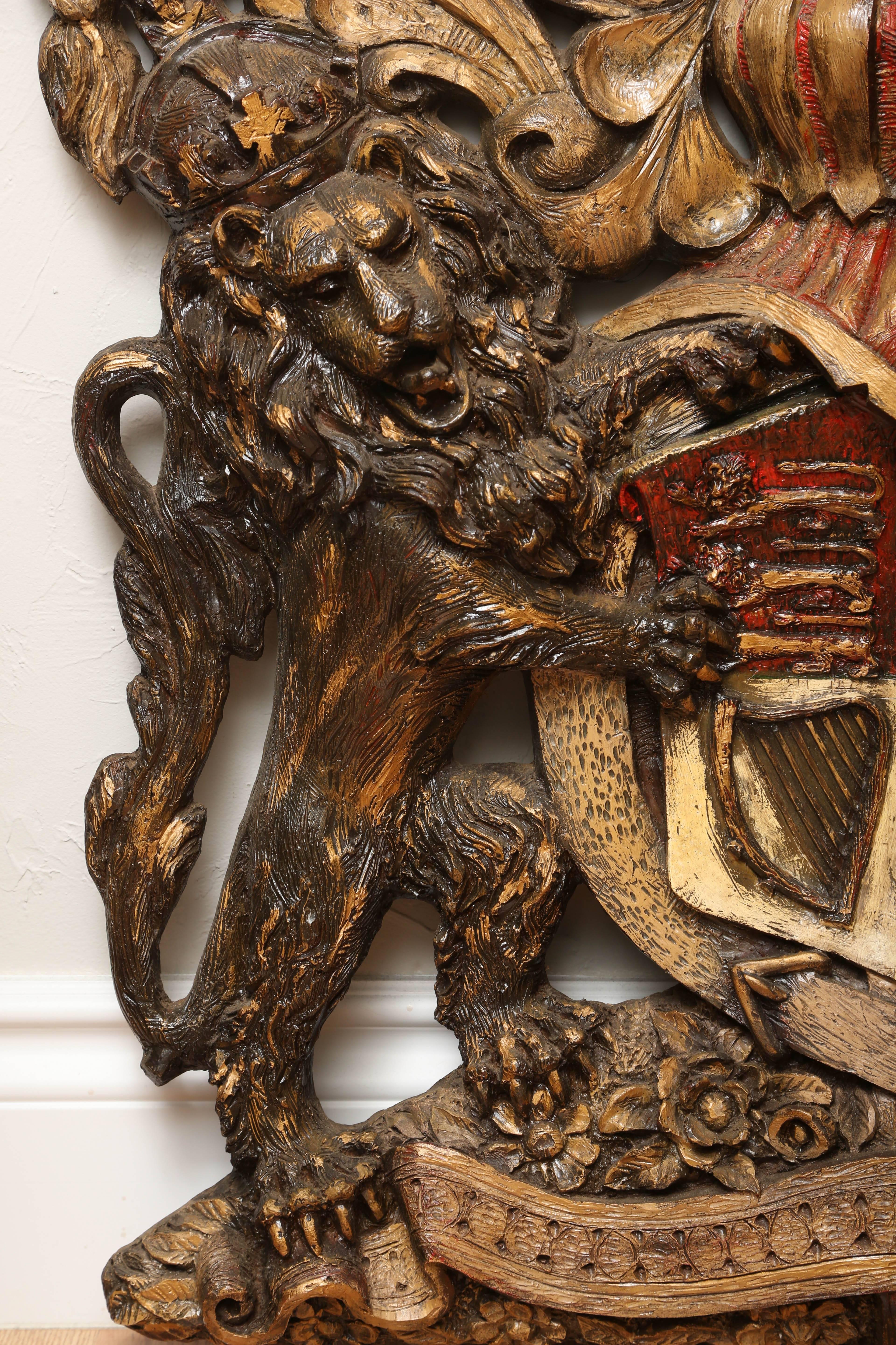 Large armorial plaque with lion and unicorn on each side and topped with a crown.