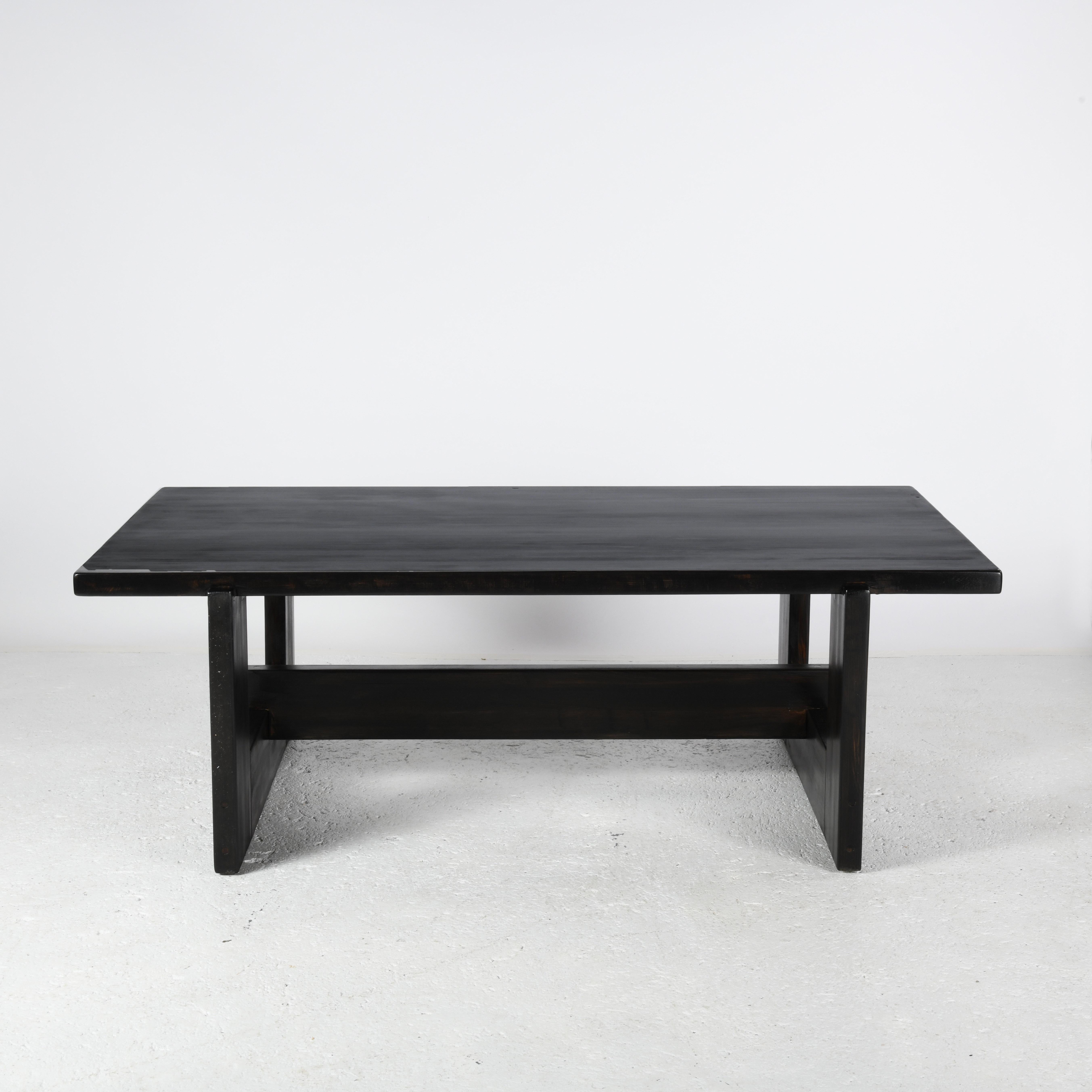 Large coffee table in black-stained solid pine from Denmark. Sober lines and beautifully assembled legs for this massive coffee table. The stain protects the wood while leaving its texture visible. The top is protected by a satin varnish for ease of