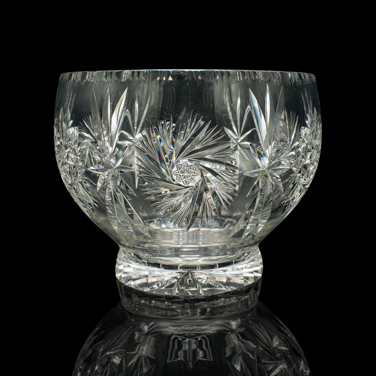 
This is a large vintage crystal fruit bowl. An English, cut glass decorative serving dish, dating to the mid 20th century, circa 1960.

Of fascinating proportion and high decorative appeal
Displays a desirable aged patina and in good original