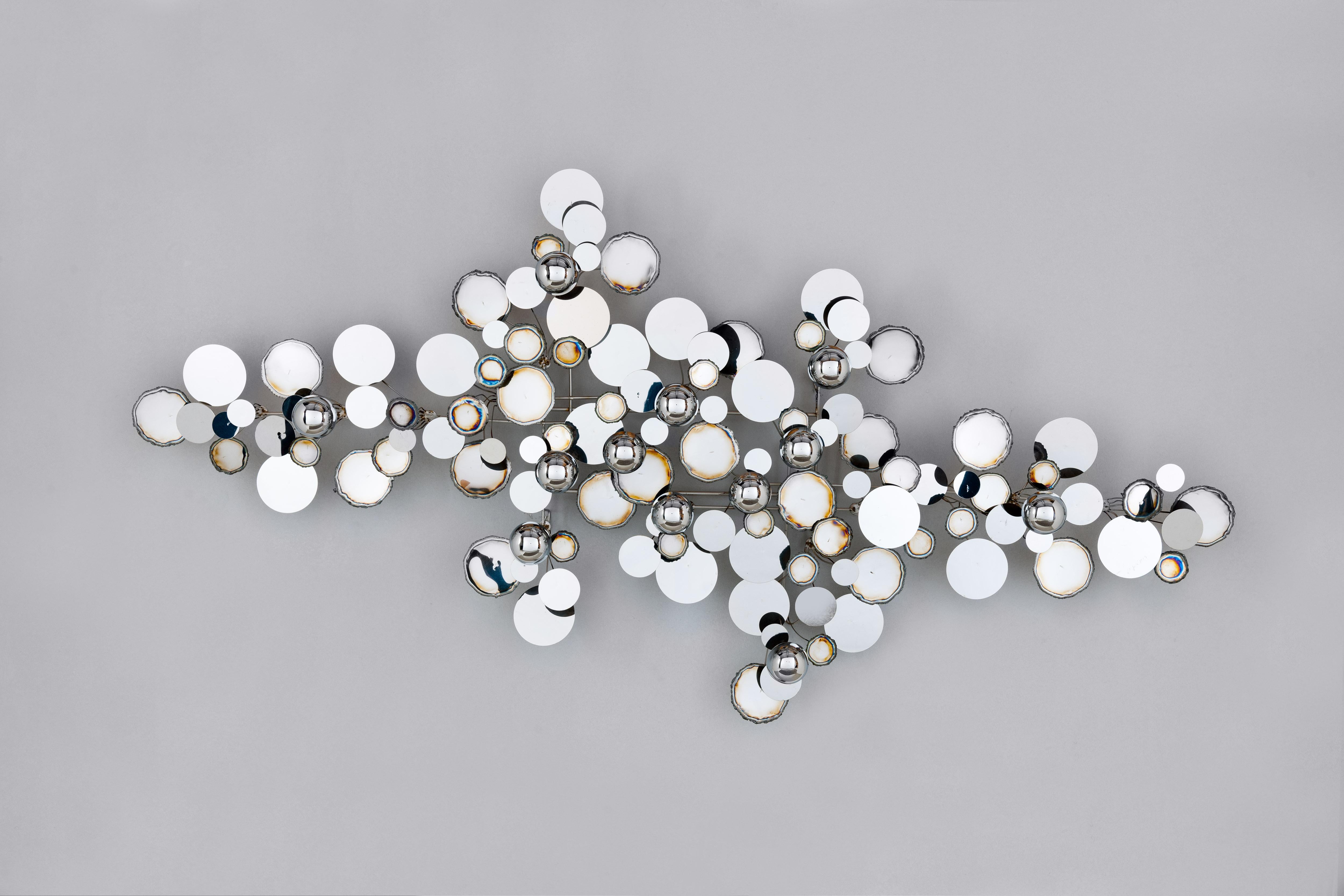 Iconic largest size vintage 'Raindrops' wall sculpture by C. Jere / Artisan House, in chrome execution. 
Abstract metal wall sculpture of torched edge disc's and half spheres made originally between 1965-1979. Object is fully signed 'C. Jere'