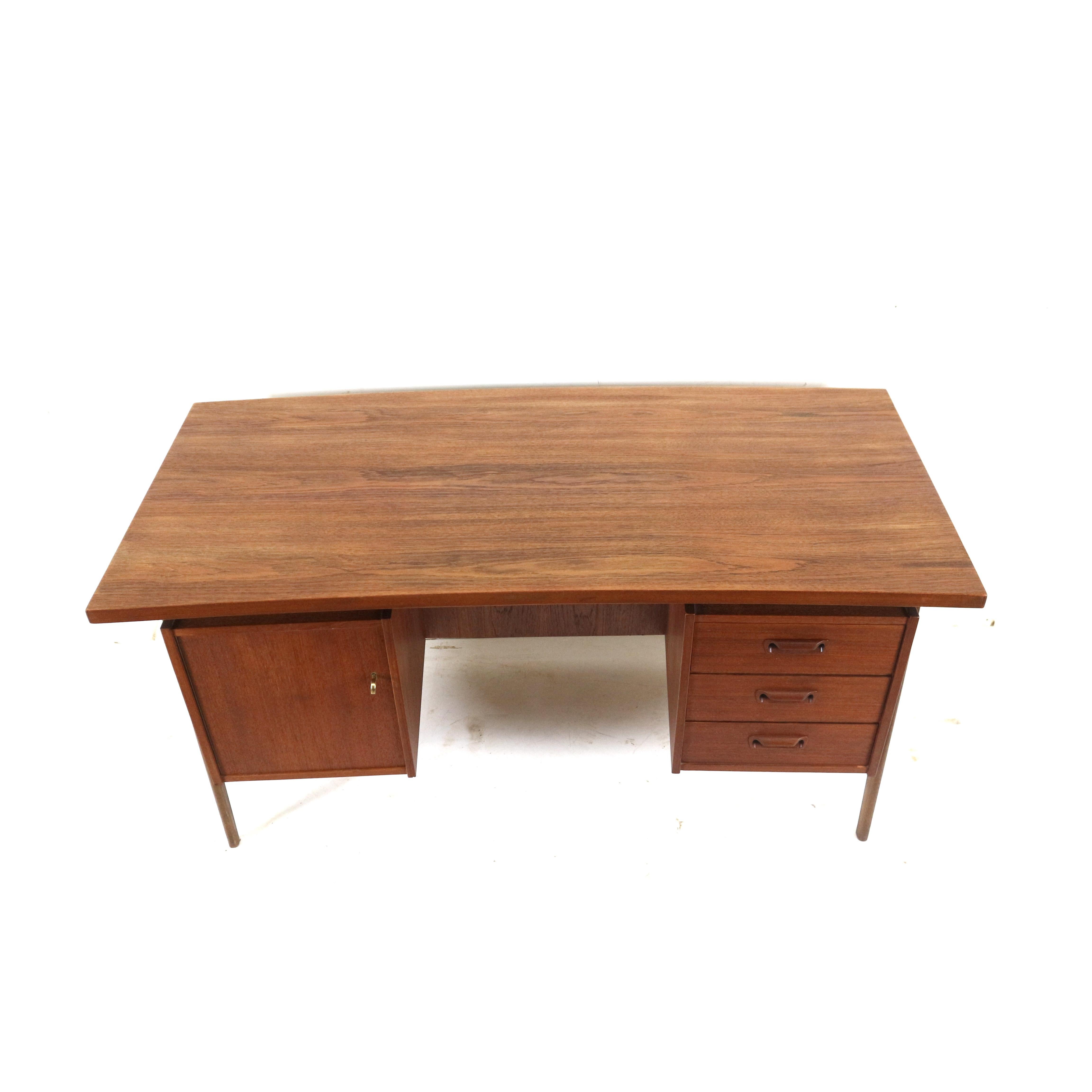 Large vintage Danish design boomerang desk made of teak. The desk is also beautifully finished on the back and can therefore be placed well in the middle of a room.

Dimensions:
Width: 154.6 cm
Depth: 80 cm
Height: 75.2 cm

Dimensions compartment