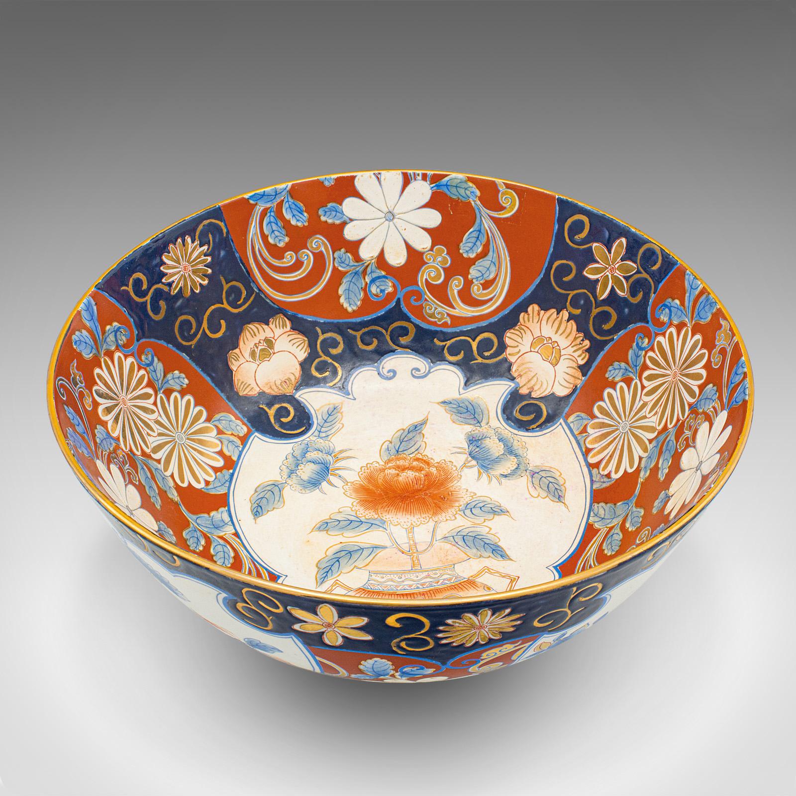 This is a large vintage decorative bowl. A Japanese, ceramic serving dish in Art Deco revival Imari pattern, dating to the late 20th century, circa 1980.

Impressively broad dish accentuated with striking Imari taste
Displays a desirable aged