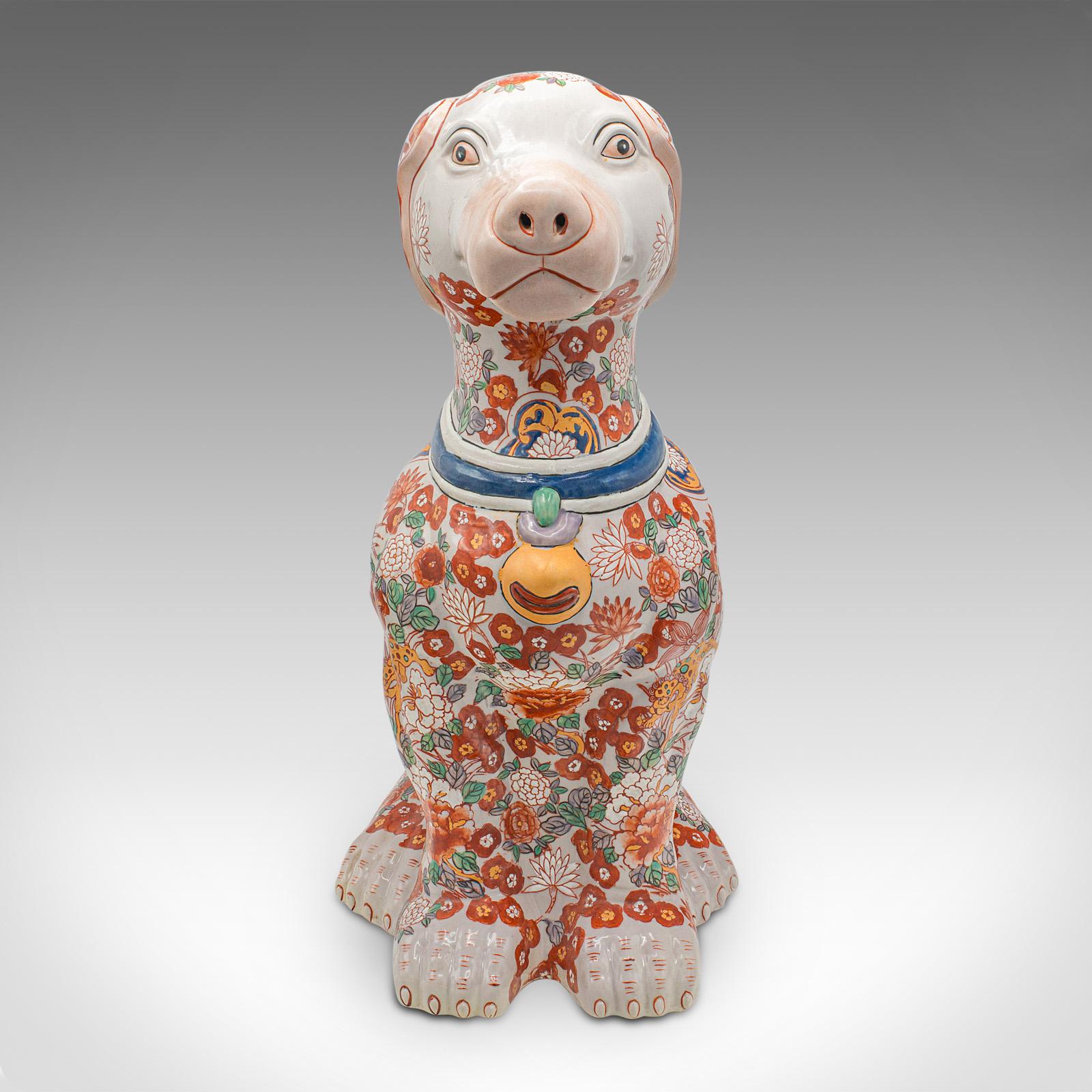 This is a large vintage decorative dog figure. A Chinese, ceramic hound statue in Imari taste, dating to the mid 20th century, circa 1950.

Of superb decorative proportion, a faithful friend for the fireside
Displays a desirable aged patina and in