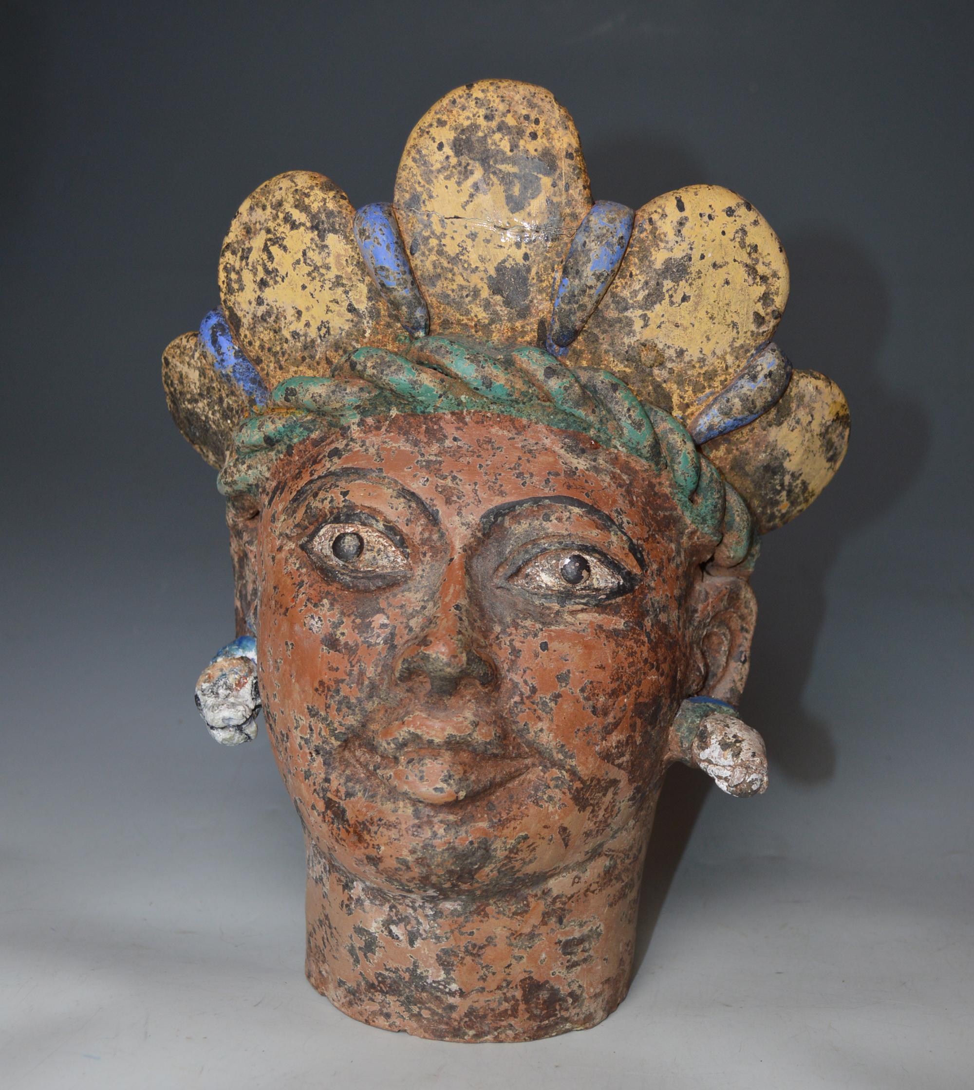 Large Vintage decorative Mexican terracotta bust Montezuma 

A Vintage pottery bust of Montezuma with headdress and ear ornaments  in red/brown terracotta with polychrome pigment decoration. Oaxaca Mexico Circa early 20th century.
Height 11 inches