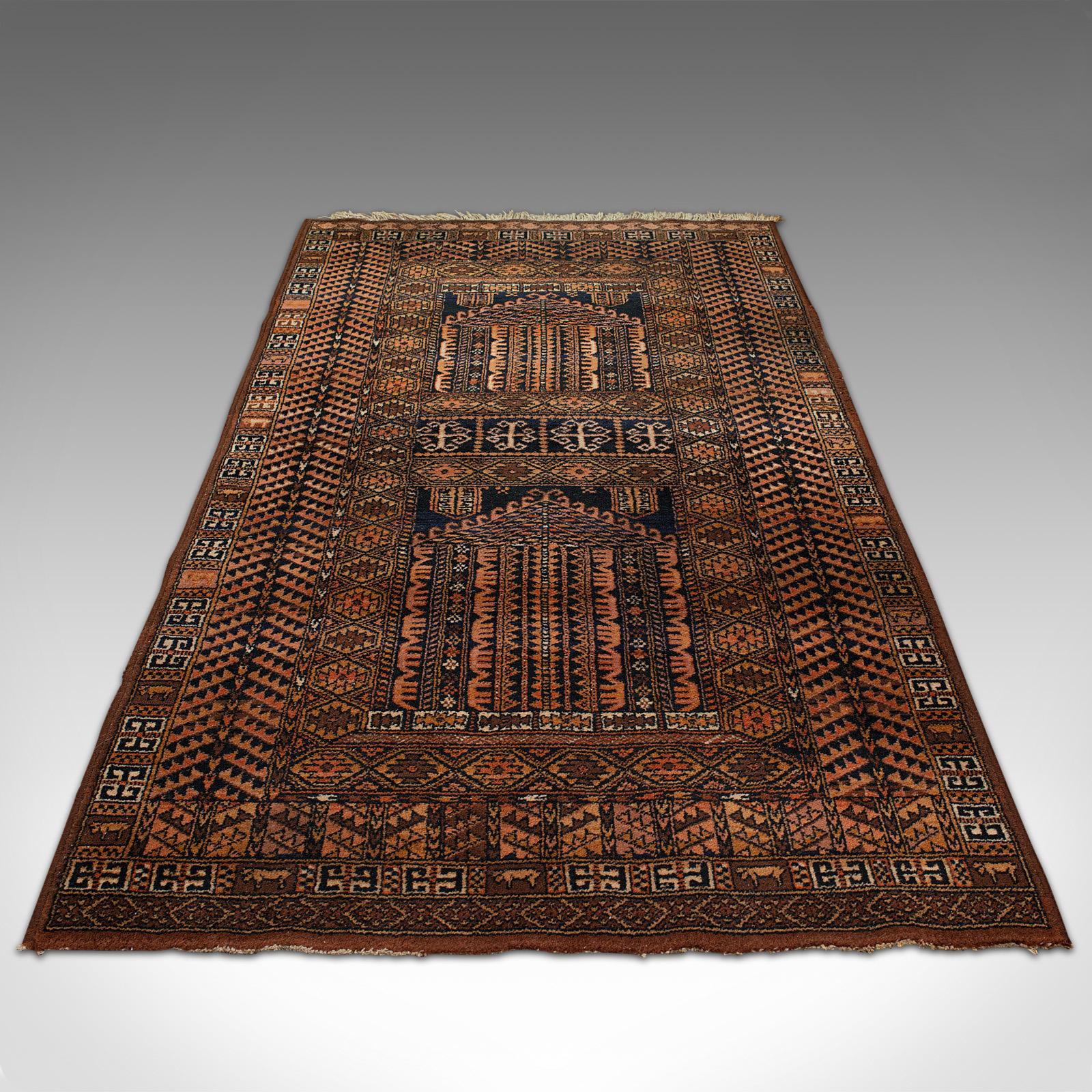 This is a large vintage decorative rug. A Belgian, quality woven lounge carpet in the manner of Ghiordes prayer mats, dating to the late 20th century, circa 1970.

Striking decorations and of near Dozar proportion at 91cm x 193cm (35.75