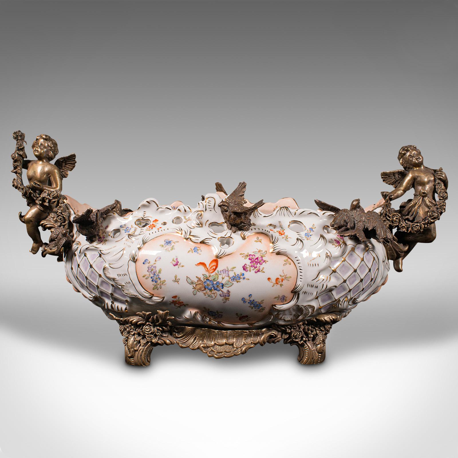This is a large vintage decorative serving dish. An Oriental, ceramic centrepiece bowl with neoclassical taste, dating to the late 20th century, circa 1980.

Wonderfully decorated with extravagant gilt mounts
Displays a desirable aged patina and