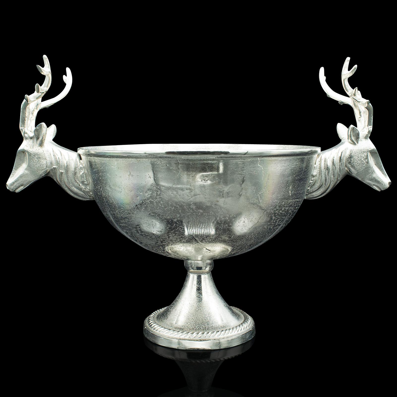 This is a large vintage decorative wine cooler. A Continental, white metal bottle holder or fruit bowl with striking stag head handles, dating to the late 20th century, circa 1980.

A striking centrepiece ideal for drinks parties or table