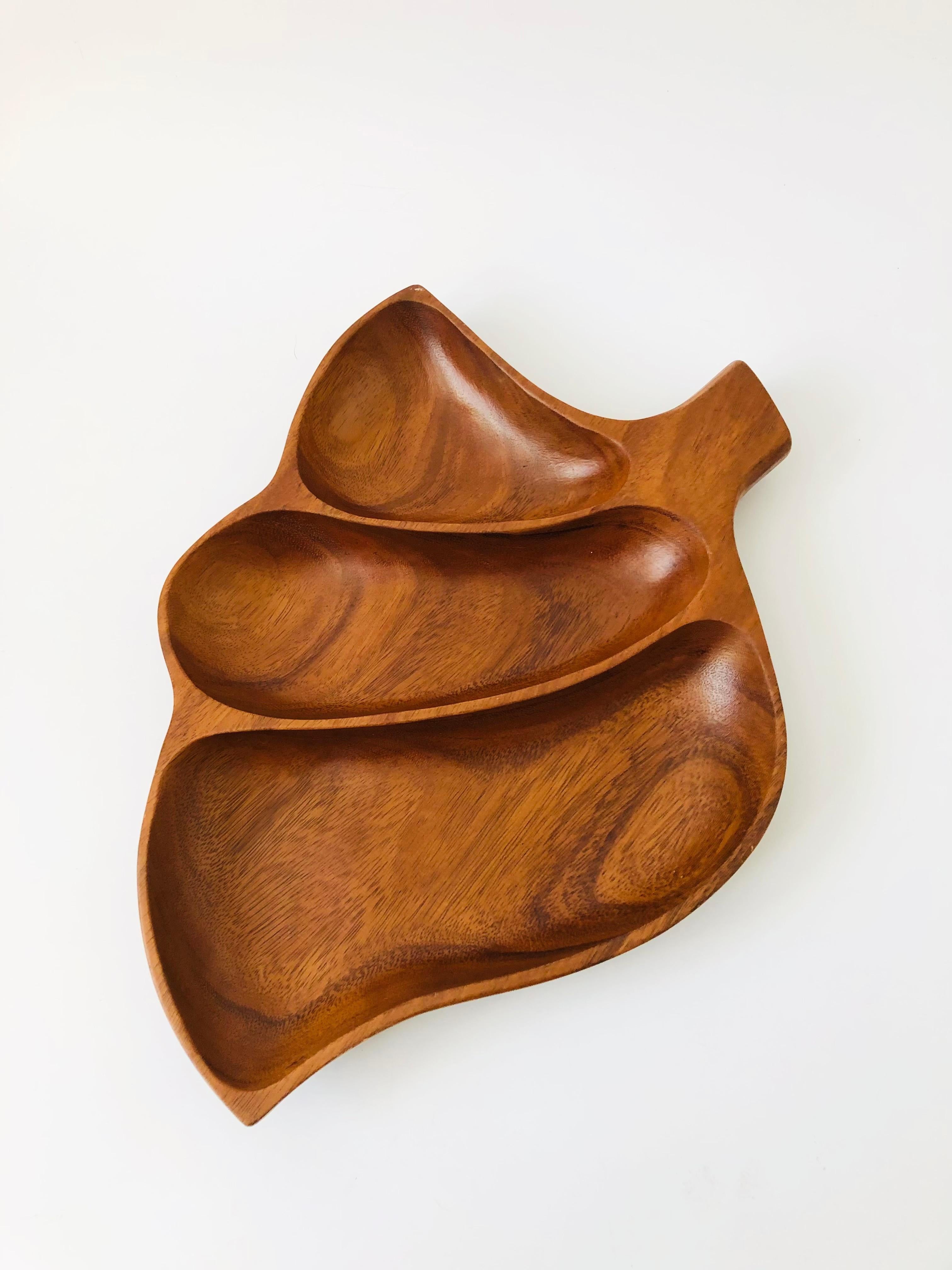 A vintage wood leaf shaped tray with 3 divided compartments for organizing or serving. Nice curved shape to the leaf.