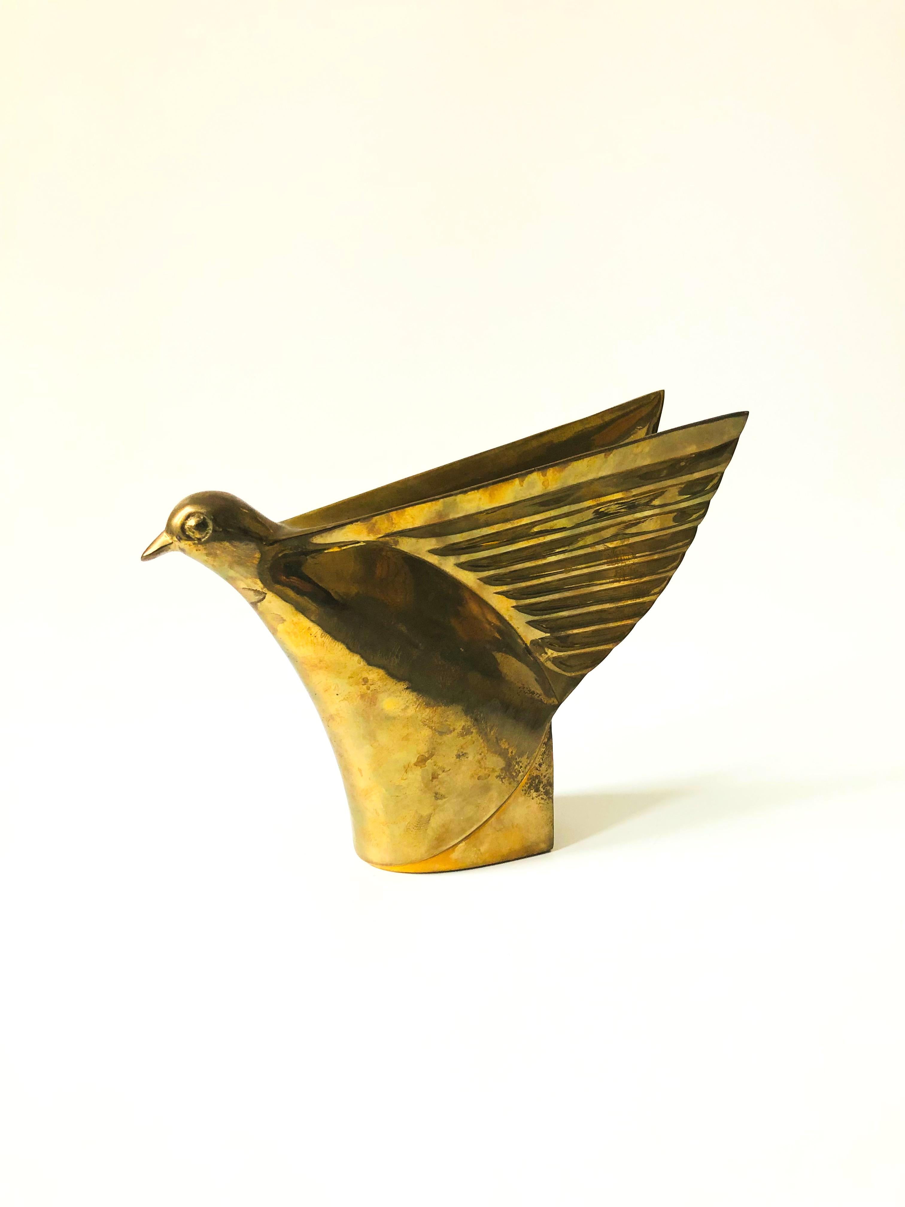 A beautiful brass bird sculpture by Dolby Cashier. Features great Art Deco stylized details.
 