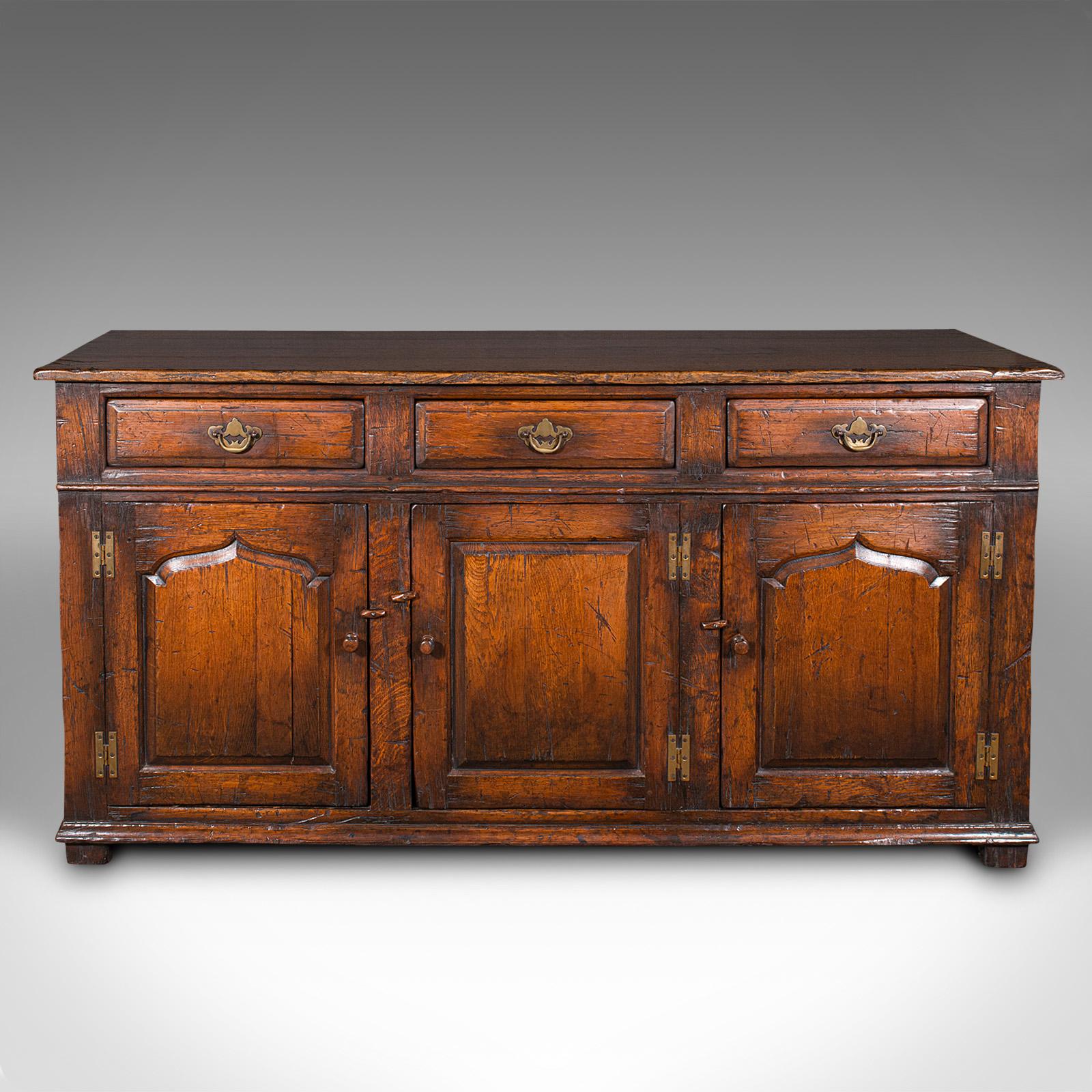 
This is a large vintage dresser base. An English, oak Georgian revival cabinet, dating to the late 20th century, circa 1980.

Of authentic Georgian taste and quality, with traditional appeal
Displays a desirable aged patina and in good
