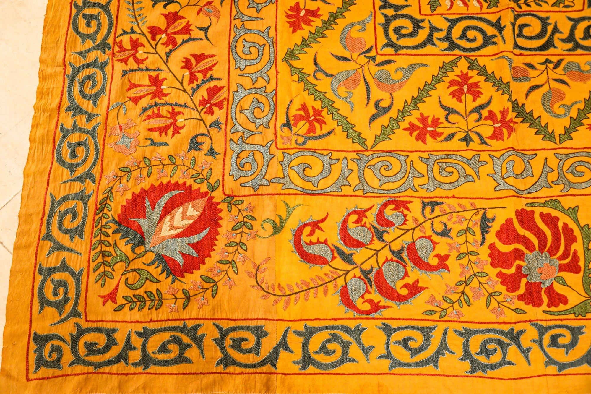 Very large vintage Turkish Suzani is heavily hand-embroidery with faded organic yellow, blue and red colors silk threading.
Beautiful Uzbek hand stitched designs with silk in traditional patterns saffron colors, red and shades of blue.
Could be hang