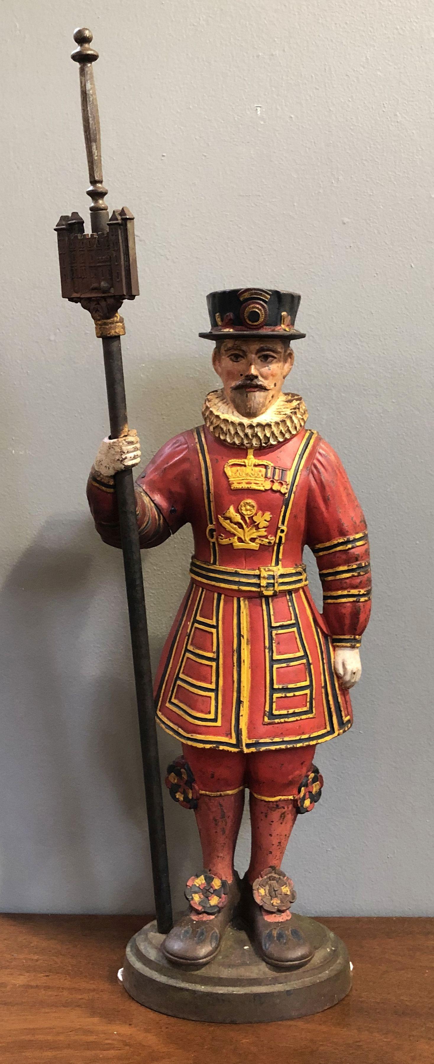 A large vintage poker stand for the fireplace from England of cast iron featuring a figure of a beefeater guard from the Tower of London.

Removable poker in the fitted Tower of London sleeve.

GR for George Rex (King George V) on front of
