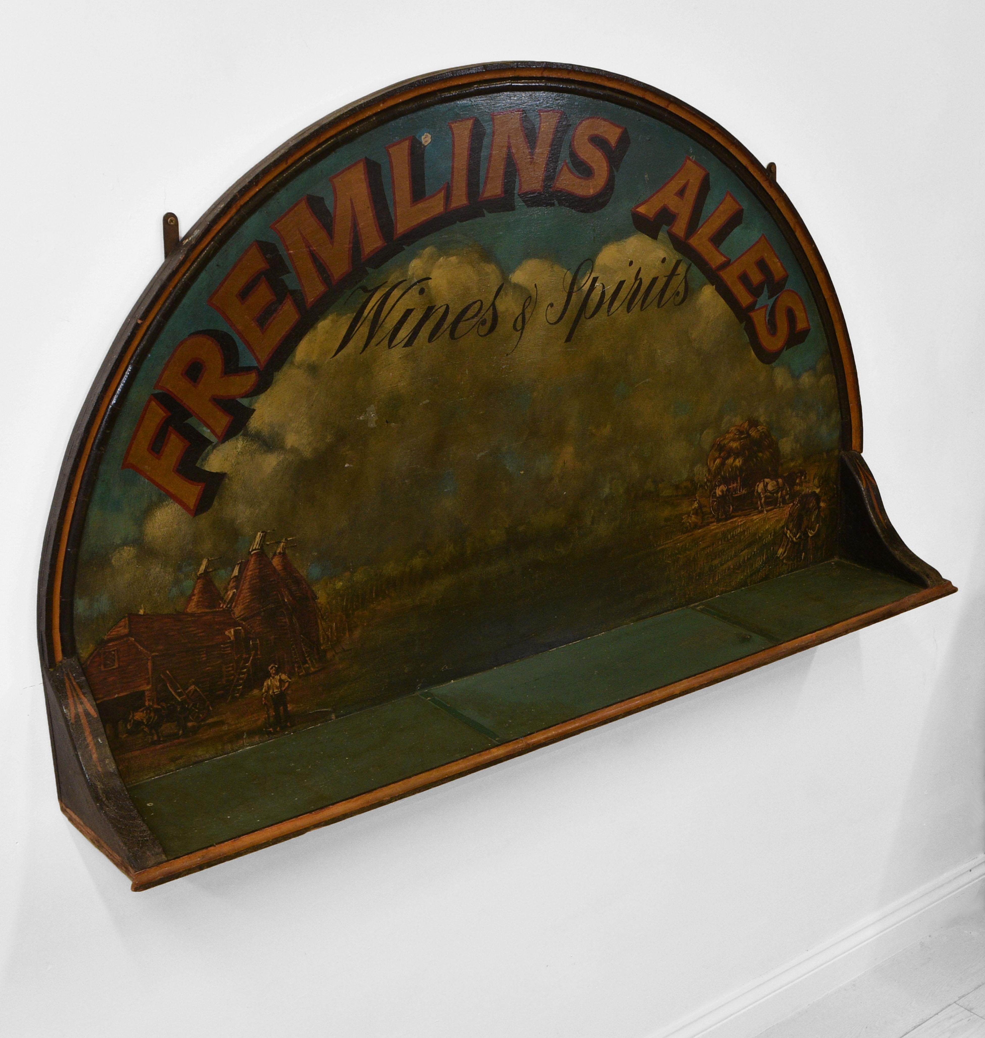 Large vintage English hand-painted brewery pub sign with shelf. 'Fremlins Ales', Kent. 1950s.

Depicting early country scenes. The central shelf would probably have been used to display Fremlins Ales. Ideal as a shelf to hold