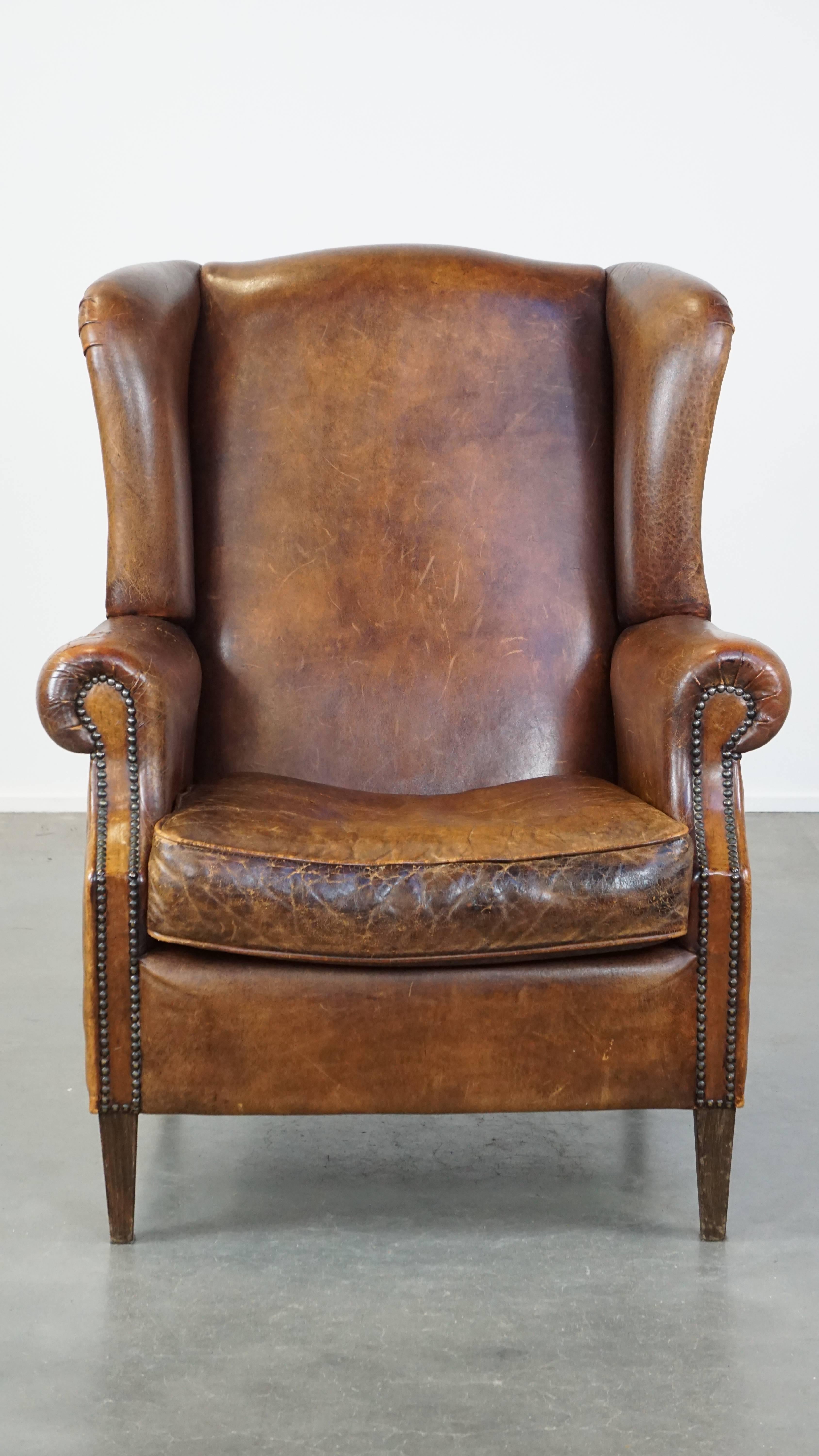 This fantastic sheepskin leather wingback armchair is the perfect addition for lovers of English-style furniture. Its warm cognac color exudes timeless class and comfort. Packed with character, this wingback armchair features a refined finish with