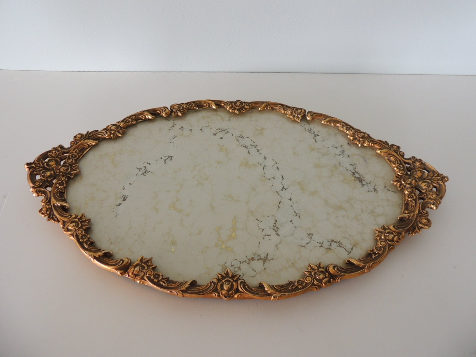 Large Vintage Filigree Gold Frame Decorative Oval Vanity Tray.
Milk glass effect and gold reversed paint aka 