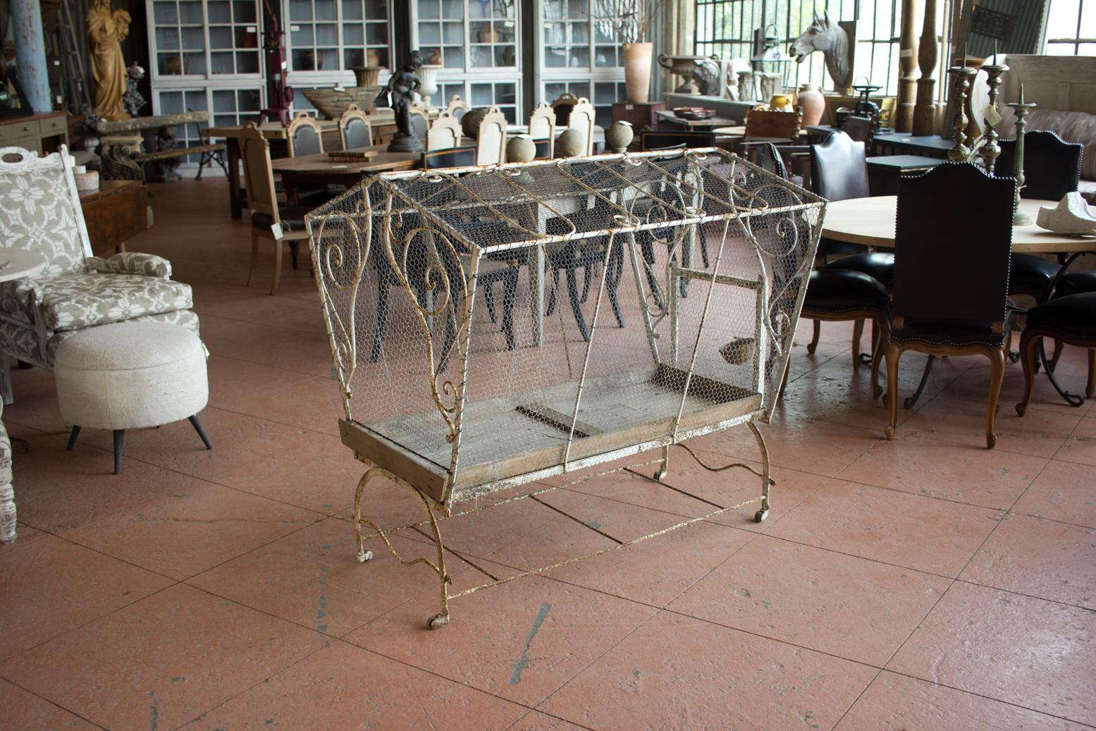 This wonderful vintage French wirework bird cage was once used as an aviary for the chaffinch song birds. It is on wheels and thus movable.

Filled with flora, it is a stunning planter!