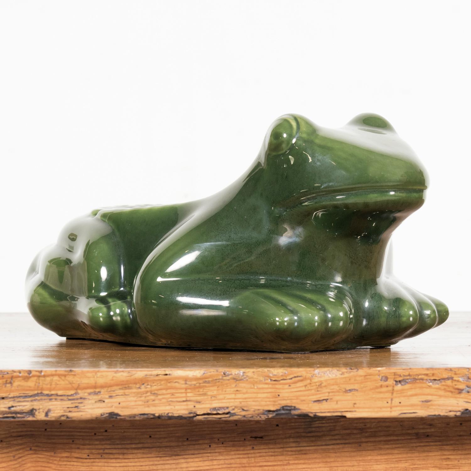 A large vintage mid-century French l'HERITIER GUYOT DIJON advertising ashtray in the shape of a frog in green enameled ceramic, circa 1950's. An iconic figure in the history of French bistros, the ceramic grenouilles or frogs adorned all the tables