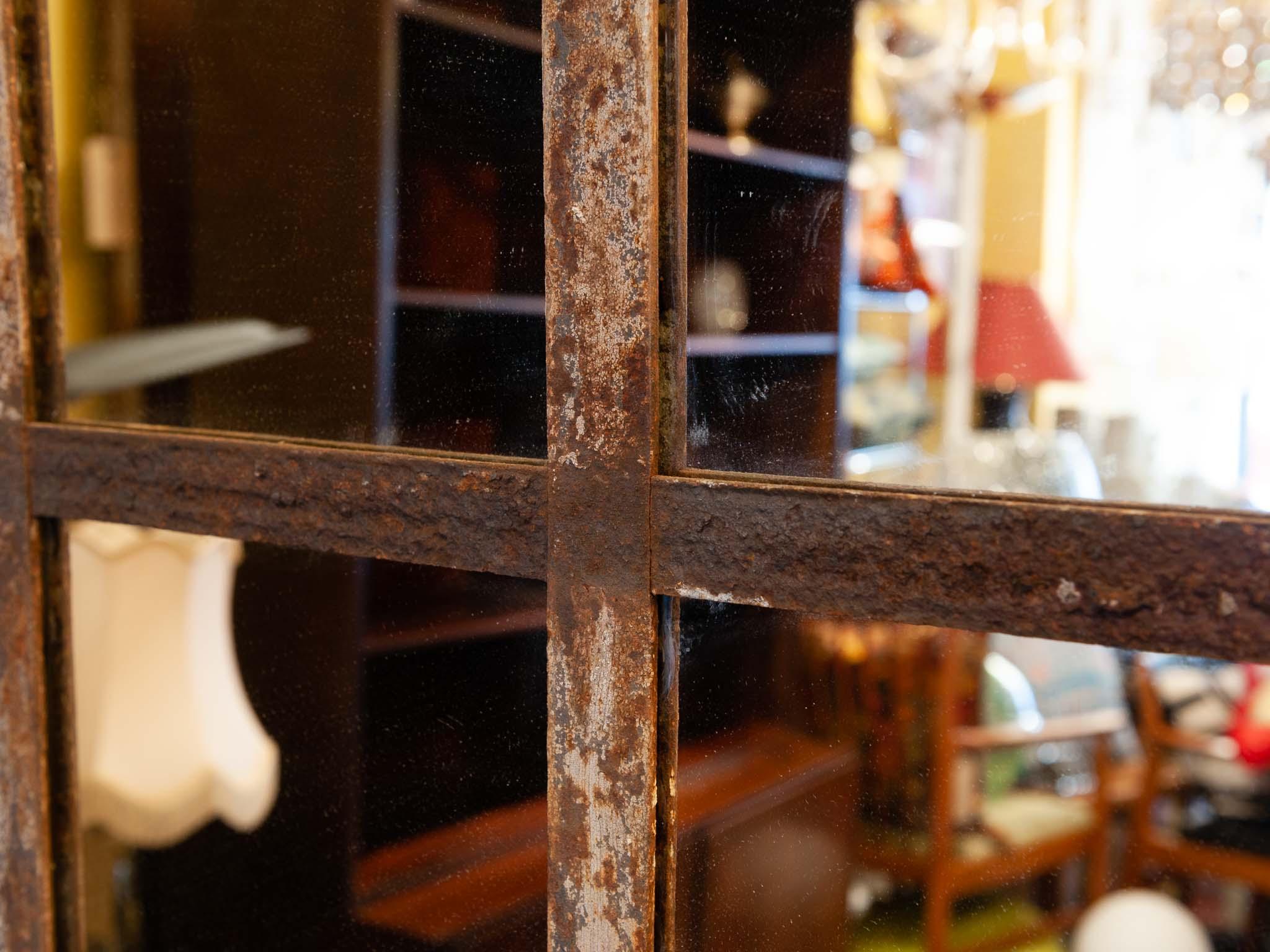 Large vintage French industrial rustic disused factory window wall mirror. The iron window-frame was reclaimed from a factory in France and converted to this amazing wall mirror. The patina of the frame is wonderfully warm, aged, rustic and rusty
