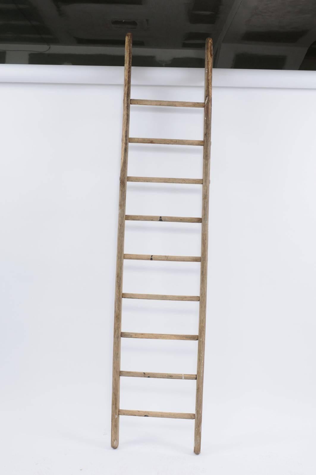 A French large vintage rustic wood and iron ladder from the first half of the 20th century. Everyone needs a ladder! Please don't use this vintage wood and iron rustic ladder to clean your gutters or wash your windows - but do use it as a charming