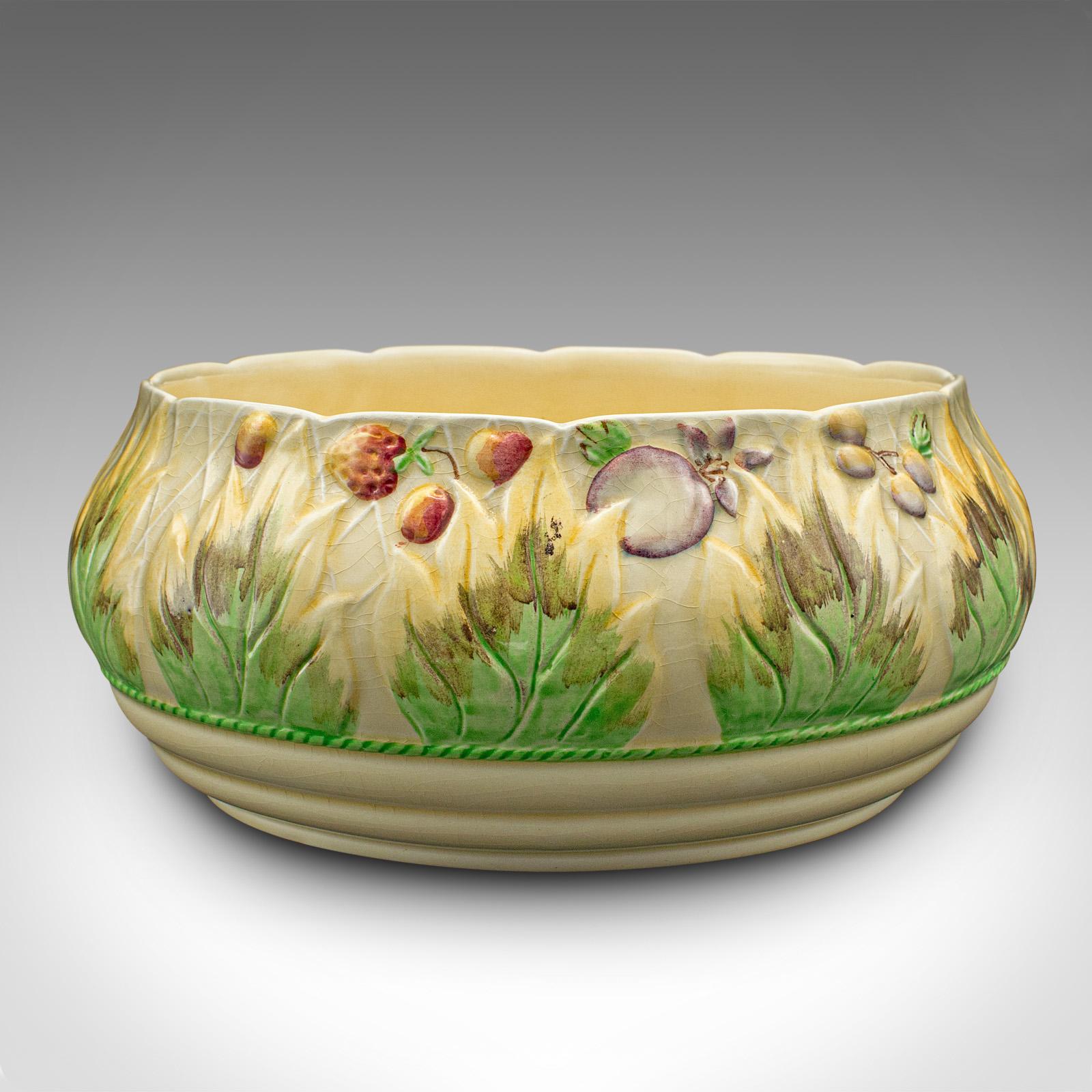 This is a large vintage fruit bowl. An English, hand painted ceramic decorative dish, dating to the early 20th century, circa 1930.

Wonderful countryside appeal to this charming fruit bowl
Displays a desirable aged patina and in good order
Ceramic